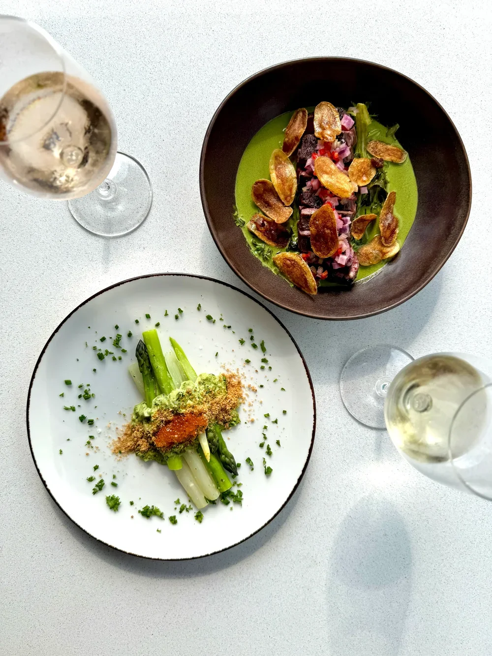 Seasonal asparagus plate paired with local beef and natural white wine at Cork Restaurant in Stowe, Vermont