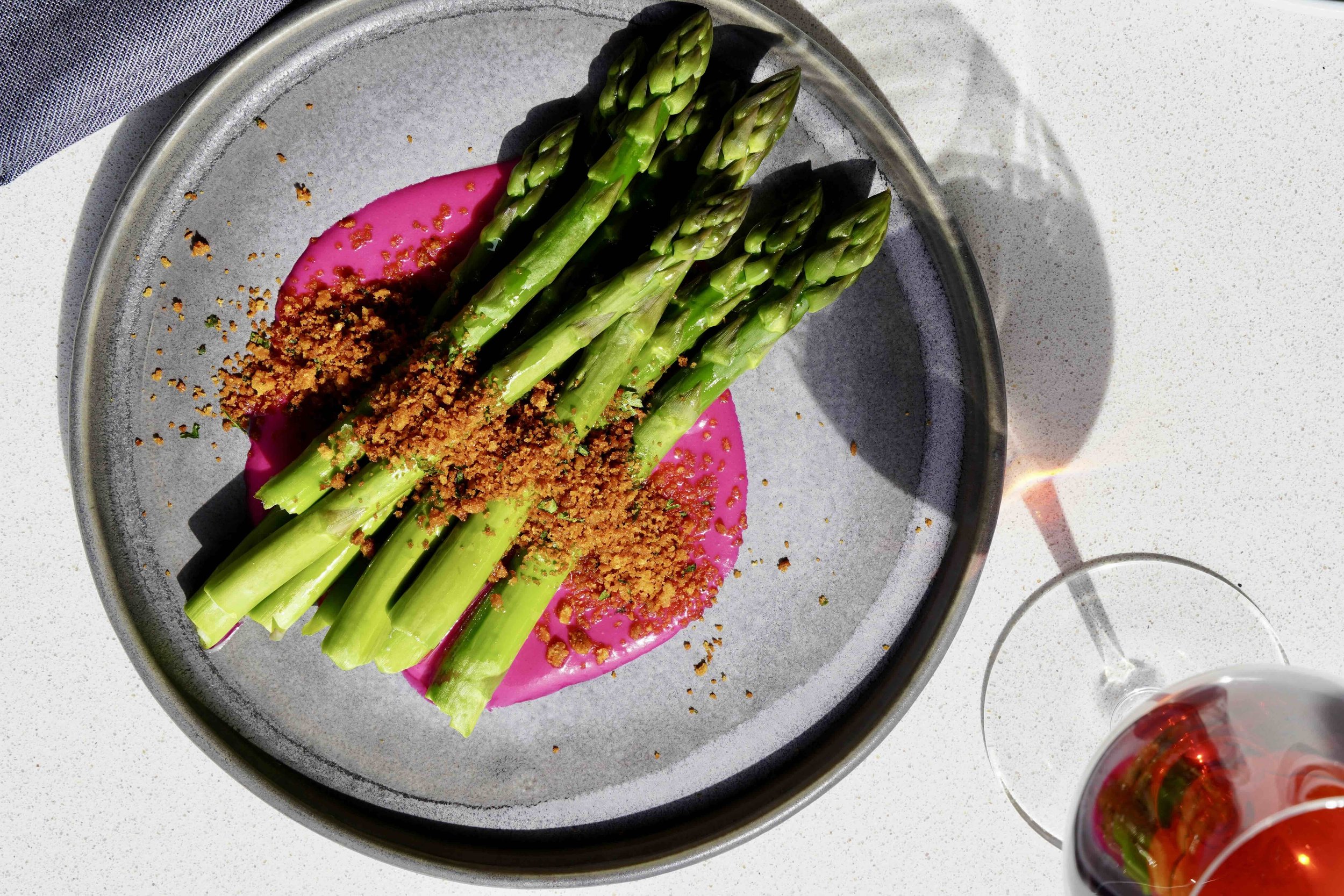 Chef Weston's local asparagus atop of bed of beet puree with a breadcrumb topping