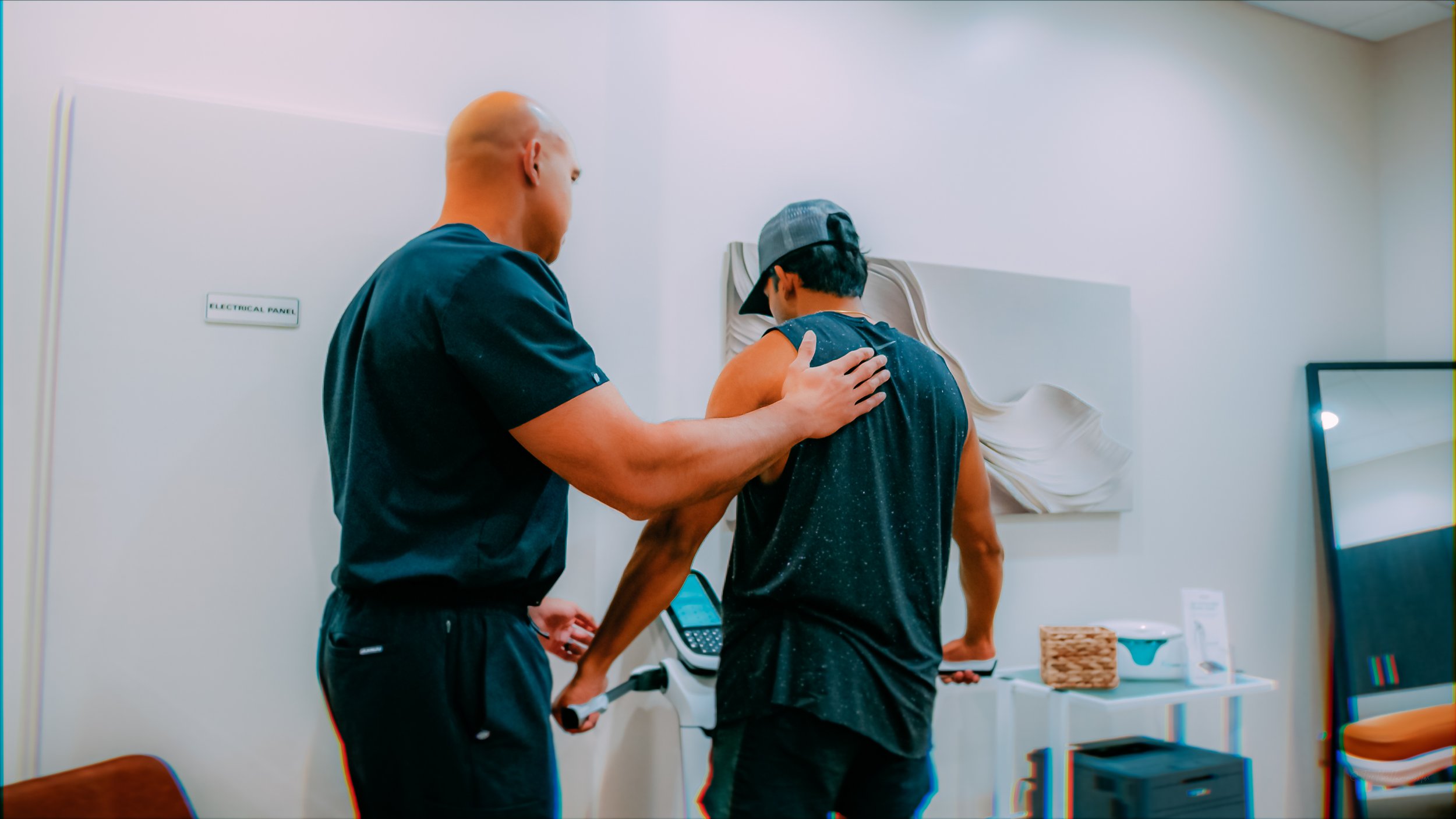 A person getting vaccinated by a healthcare worker in a clinic setting.