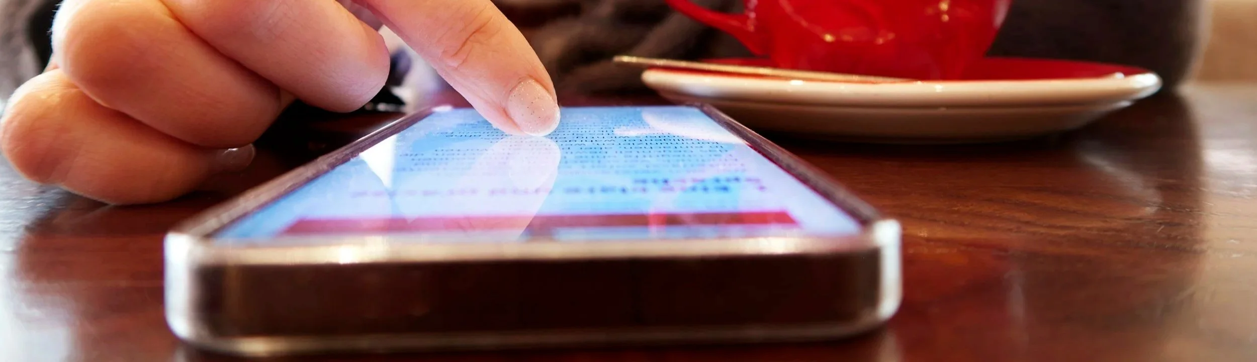 Close up shot of someone scrolling on a smartphone.