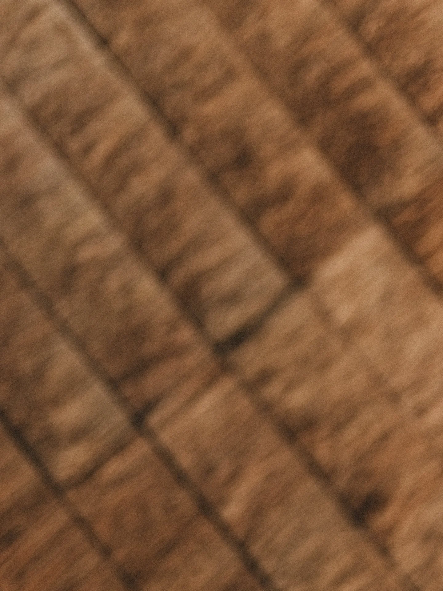 Close-up of a wooden or bamboo surface with a grid pattern, possibly a woven mat or furniture.