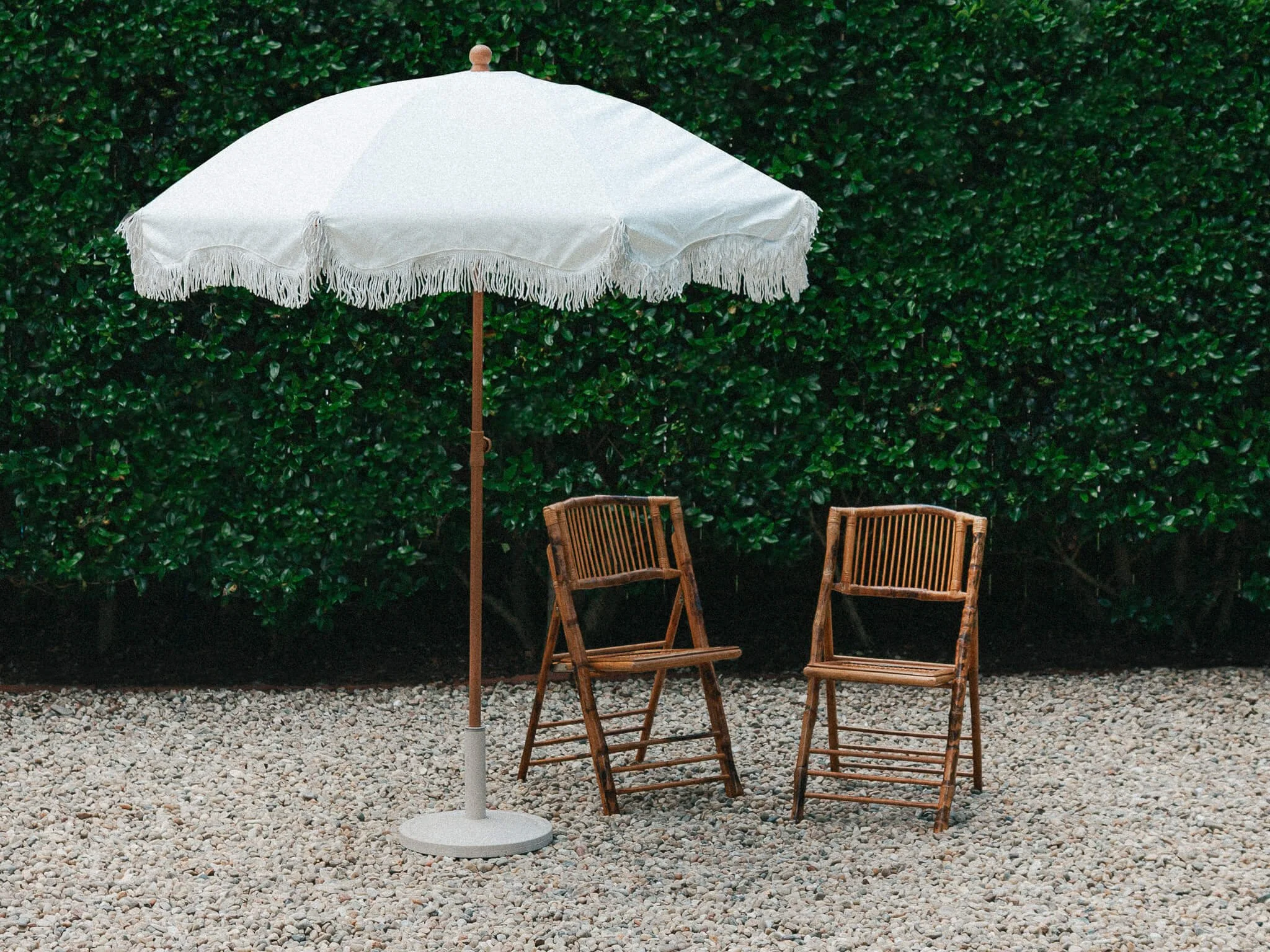 White Fringe Umbrella - front angle with bamboo chairs - VERY COMPRESSED - for squarespace website.jpg