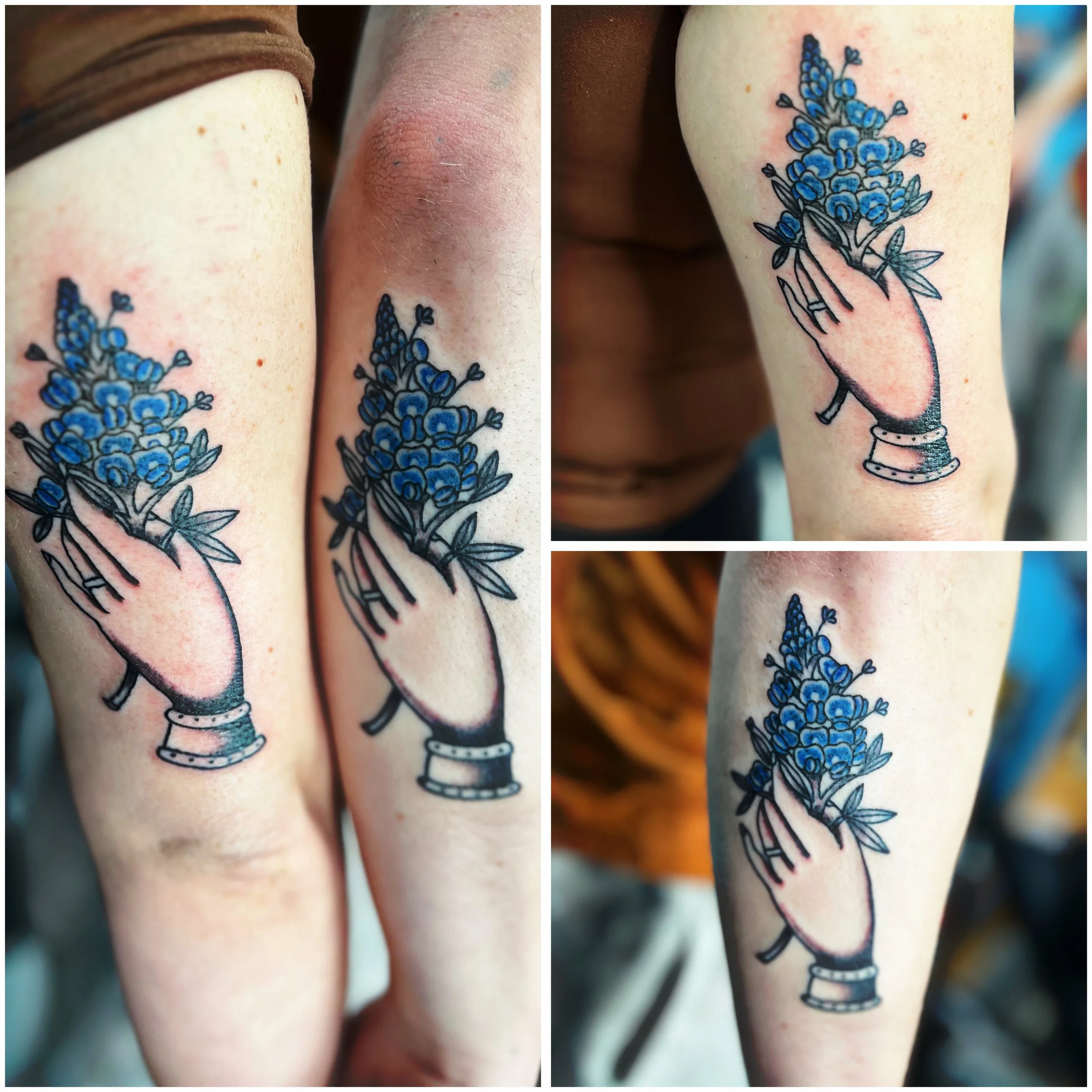 Close-up of a tattooed arm featuring a colorful flower design with multiple blue flowers and a black outline, and a small illustration of a beer mug at the wrist.