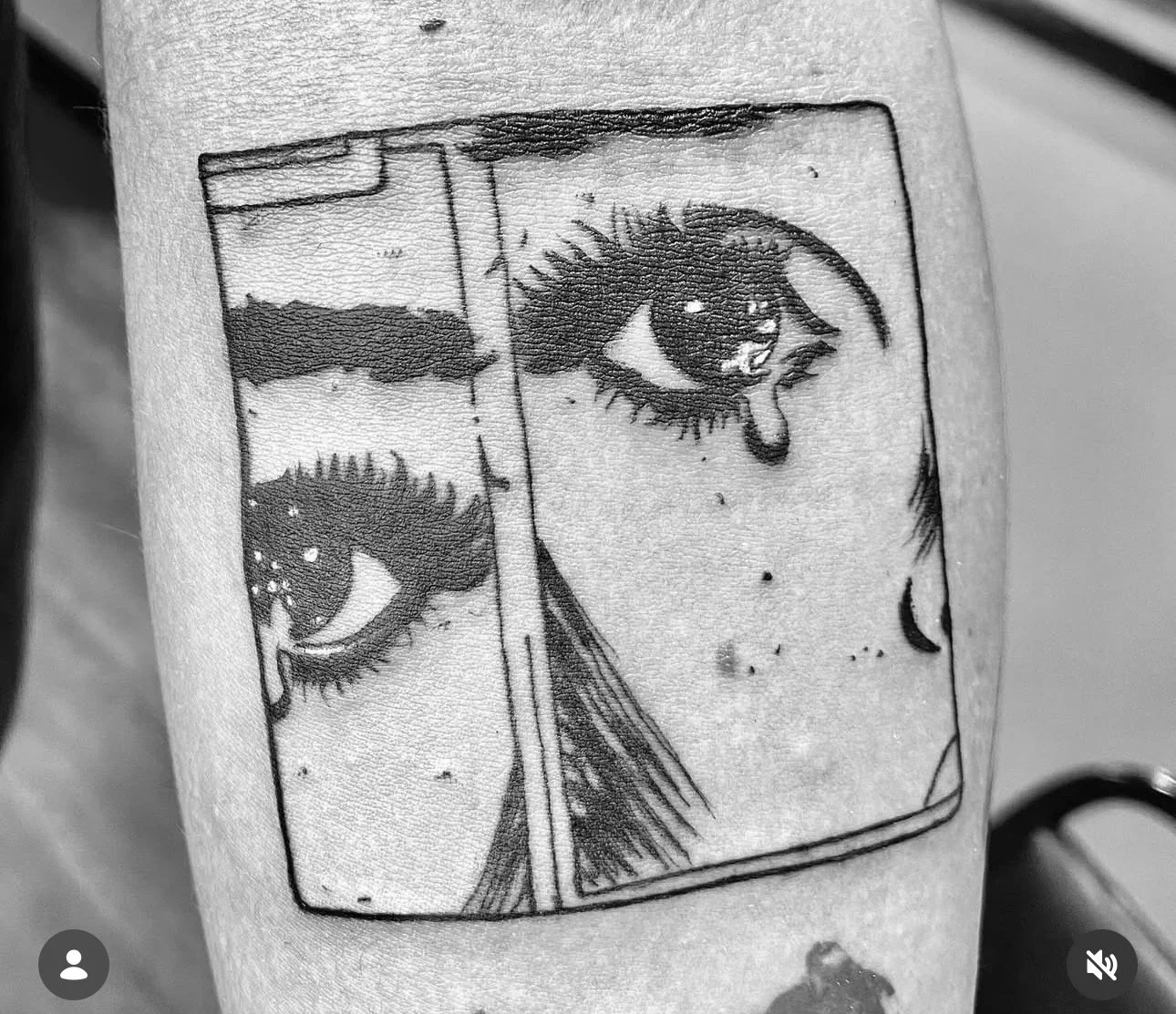 Black and white tattoo of two eyes, with one eye crying, enclosed in a rectangular border.