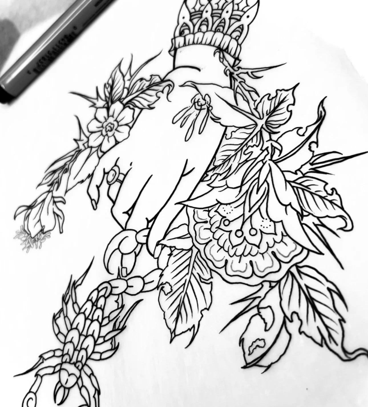 A black and white line drawing of a hand holding a flower bouquet with various flowers and leaves.