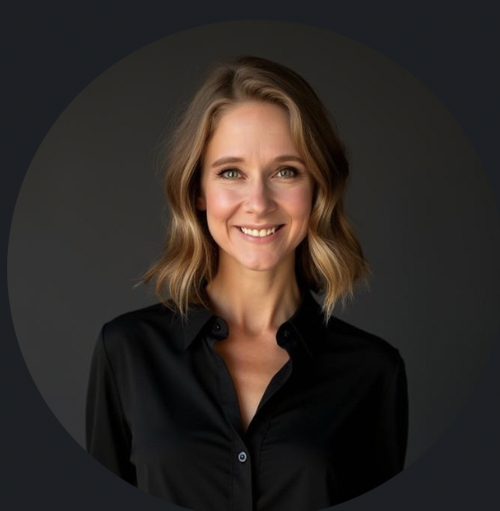 Headshot of a smiling woman with shoulder-length wavy blonde hair, wearing a black button-up shirt against a dark background.