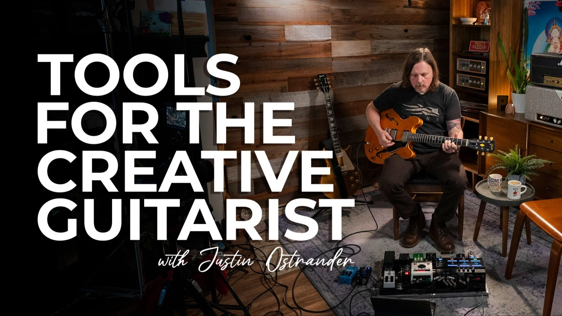 ith long hair playing an electric guitar in a cozy, wooden-paneled music studio. The image features guitar equipment, a small table with coffee mugs, and a comfortable chair, with large text overlay reading "Tools for the Creative Guitarist with Justin Ostrander."