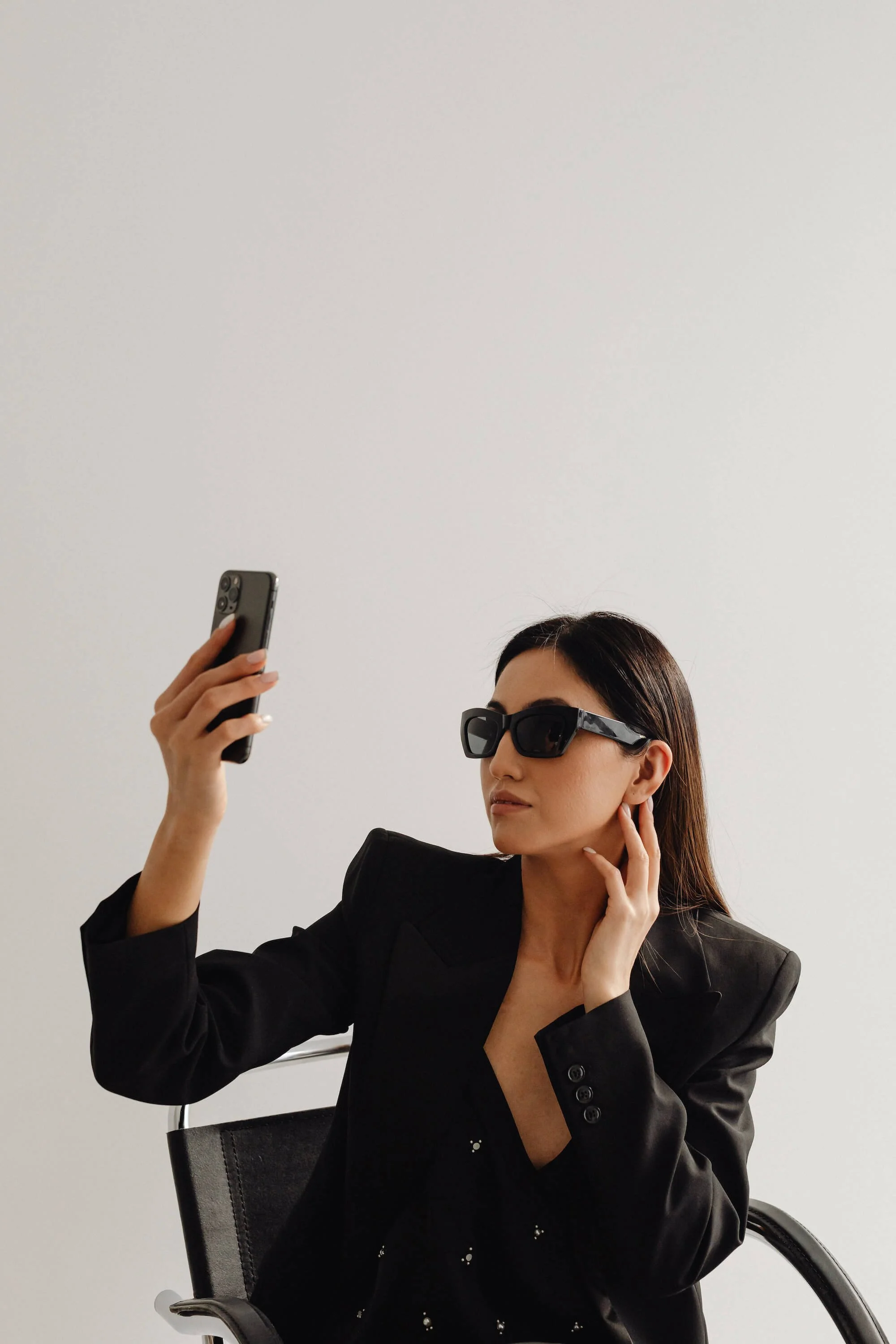 kaboompics_dark-classy-aesthetic-fashion-beautiful-asian-female-entrepreneur-in-black-suit-technology-and-devices-iphone-laptop-airpods-30031 (1).jpg