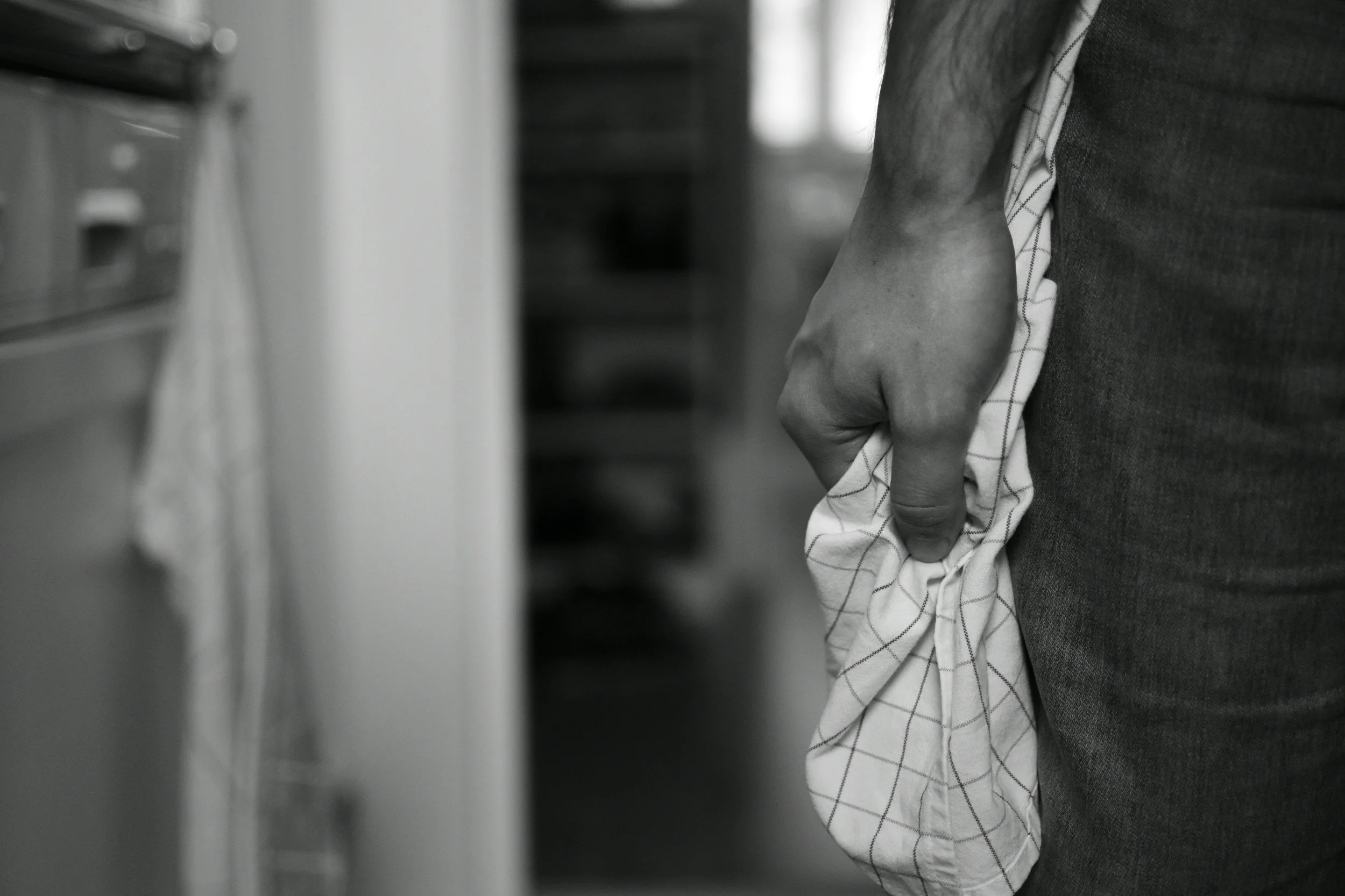 Black-and-white image of a person holding fabric