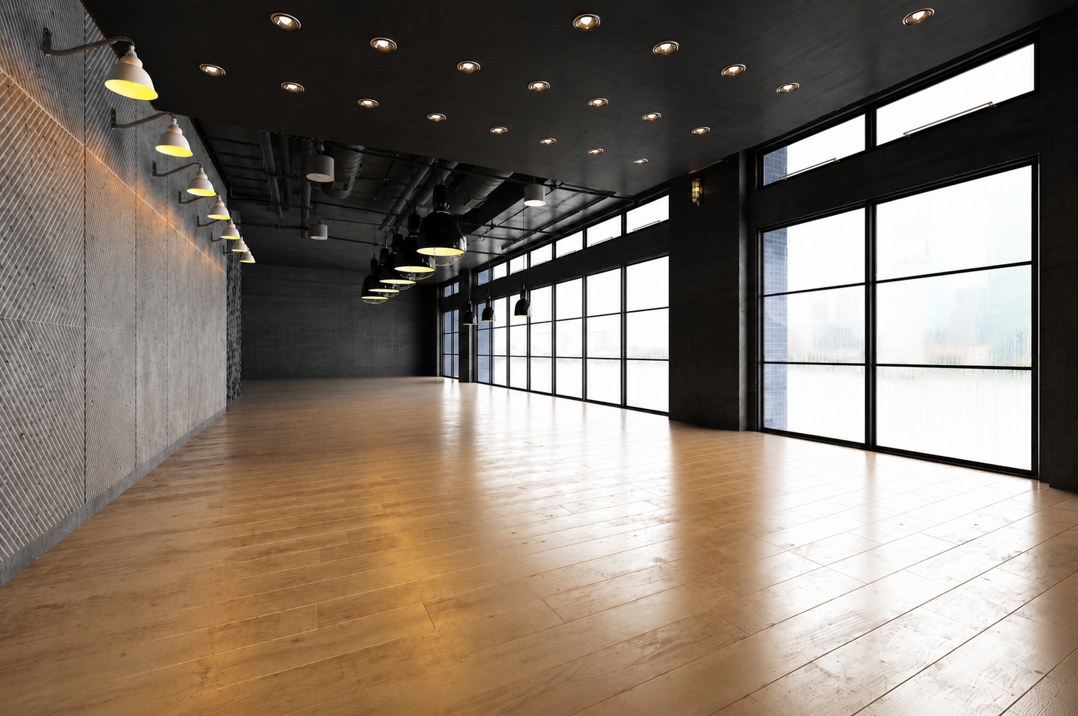 Empty modern room with recessed lighting, and hanging industrial-style pendant lights.