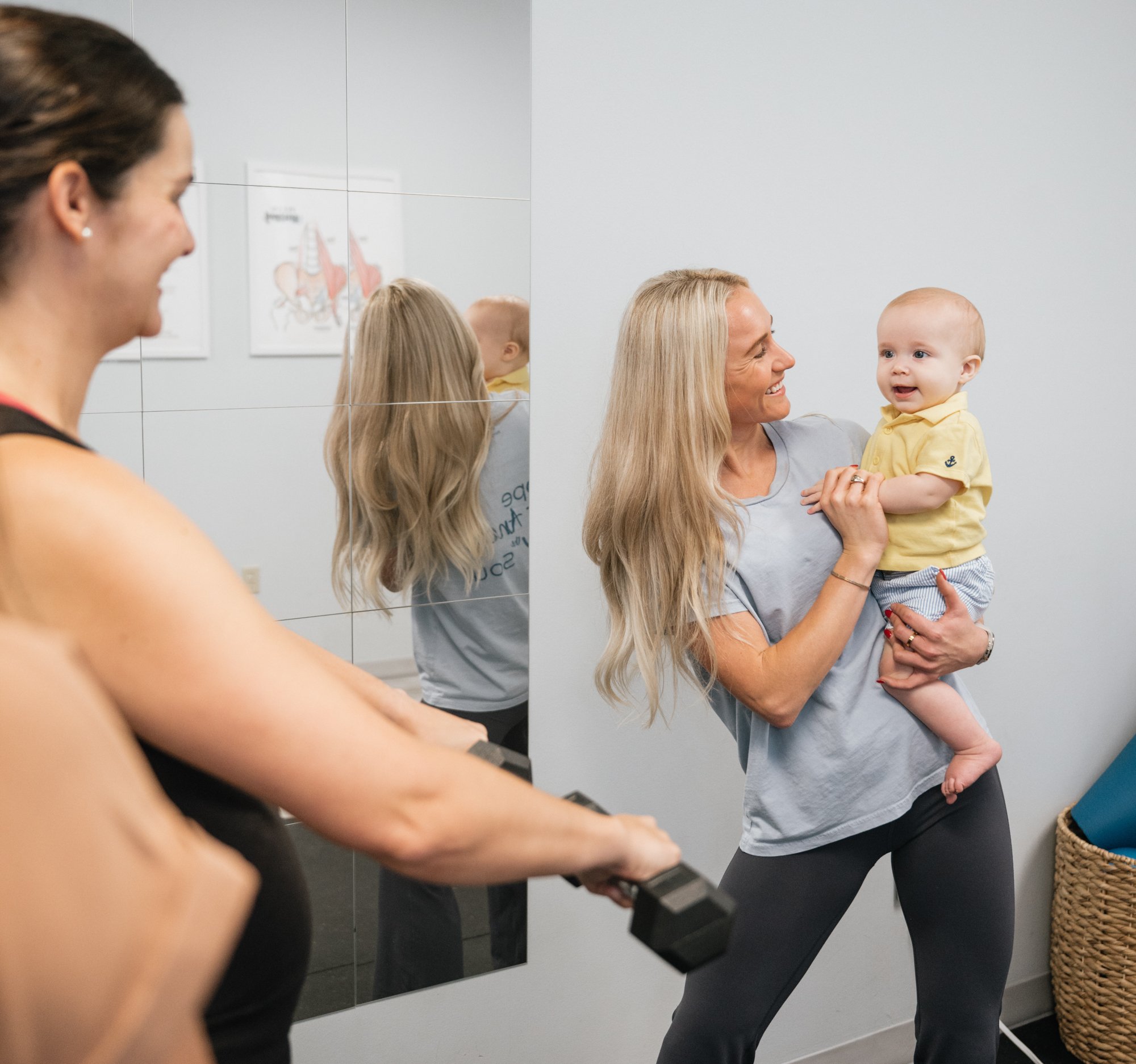 A postpartum physical therapist working with a patient after baby