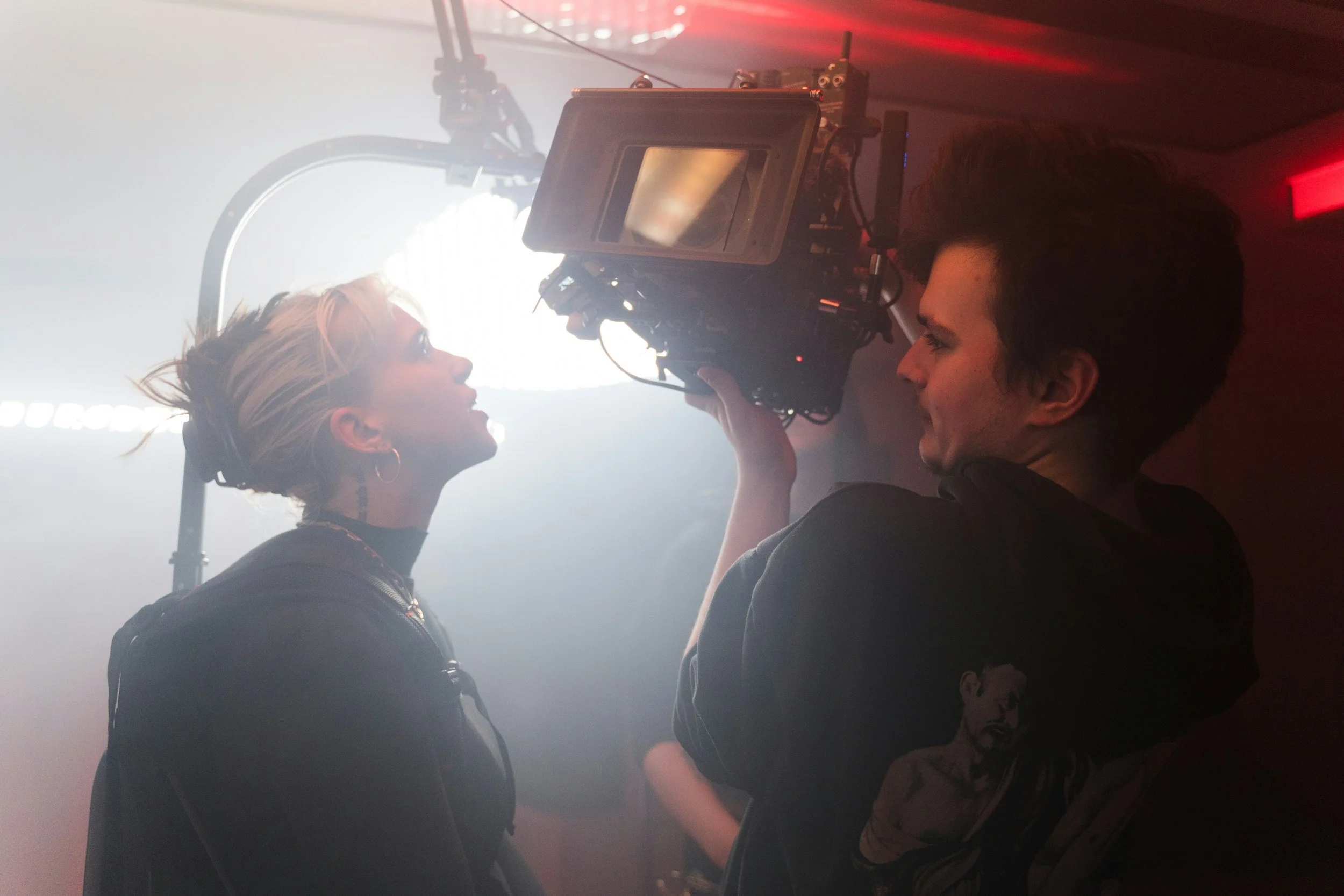 An actor performs for the camera in a scene bathed in light.