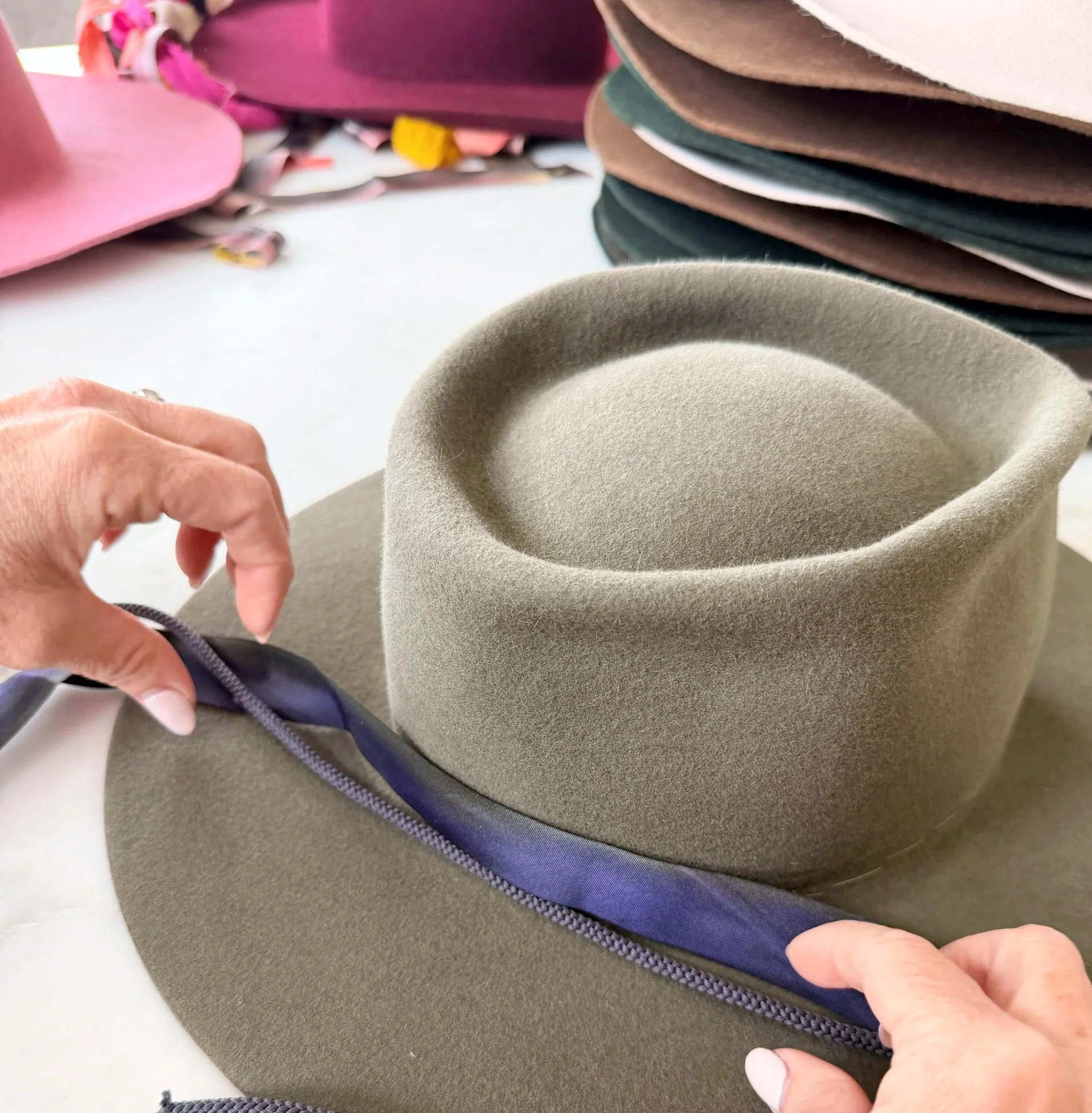 green hat putting on ribbon.jpg