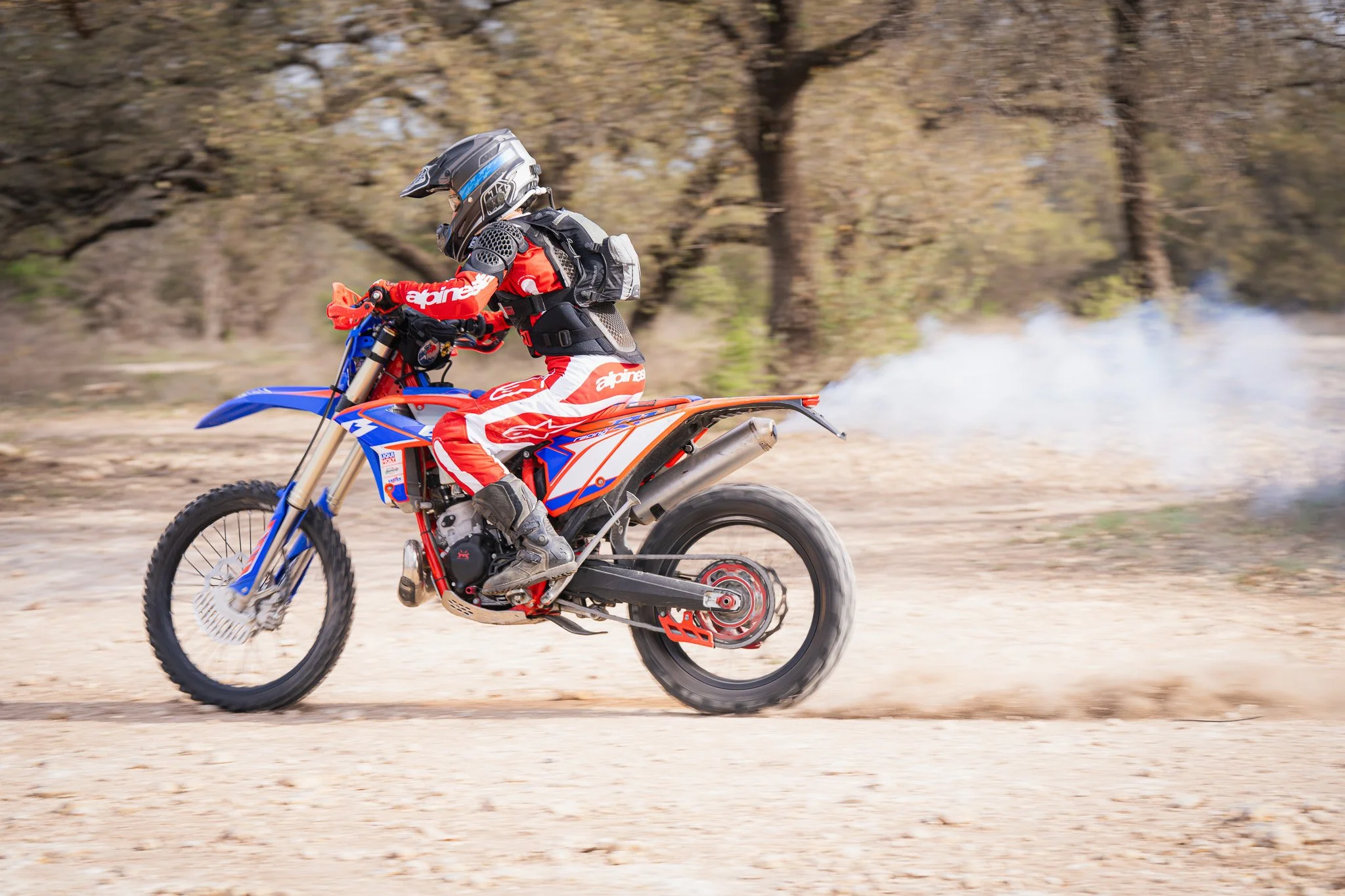 Tracking a rider on a dirt bike with exhaust fumes going "Braaap" (often spelled B.R.A.A.P.) on her Beta.