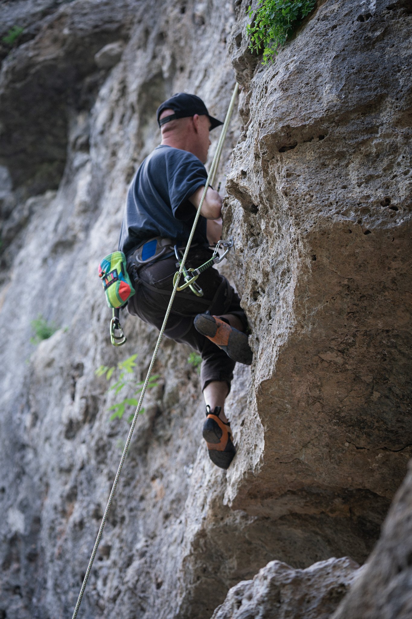 Photograph of a mountain climber lead climbing at Reimer's Ranch in the Texas Hill Country.