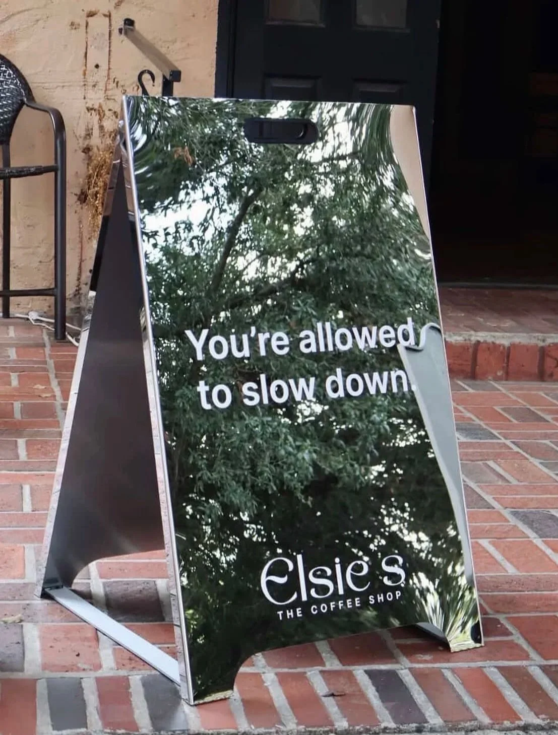 Elsie’s Coffee sign reading “You’re allowed to slow down” outside a Houston pop-up.