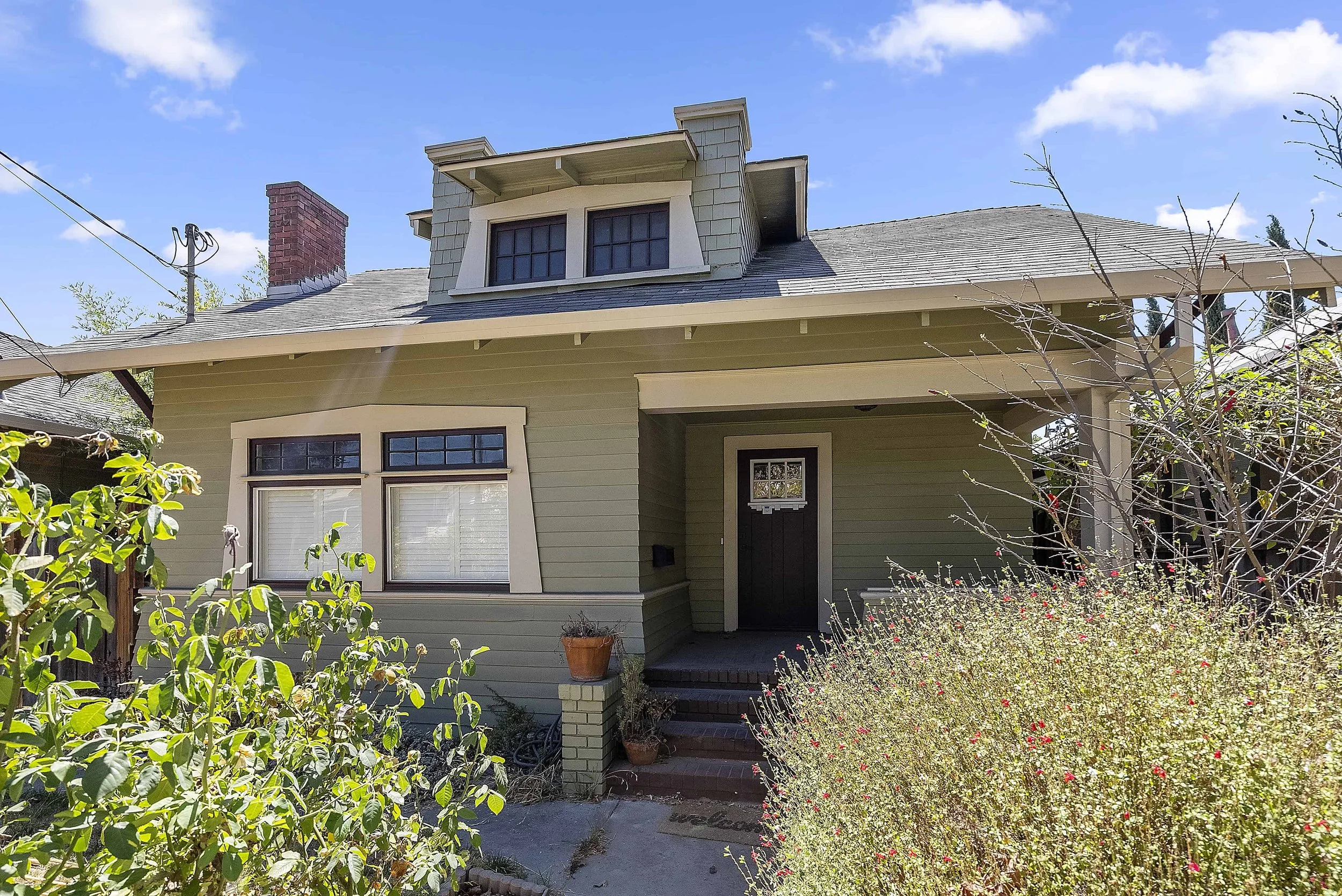 San Jose historic craftsman home with new siding and painted in sage with beige trim..
