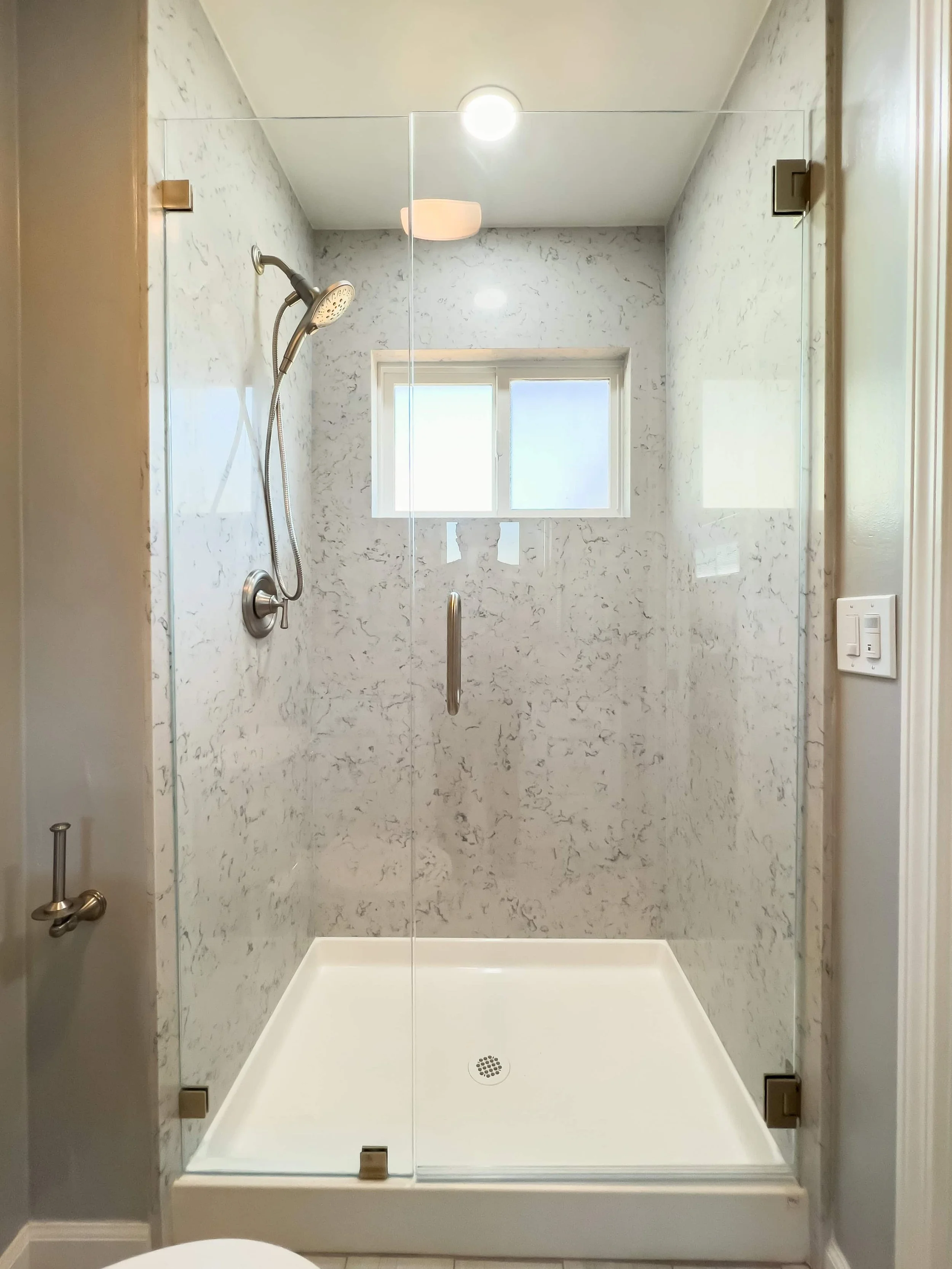 Walk in shower with a marble surround