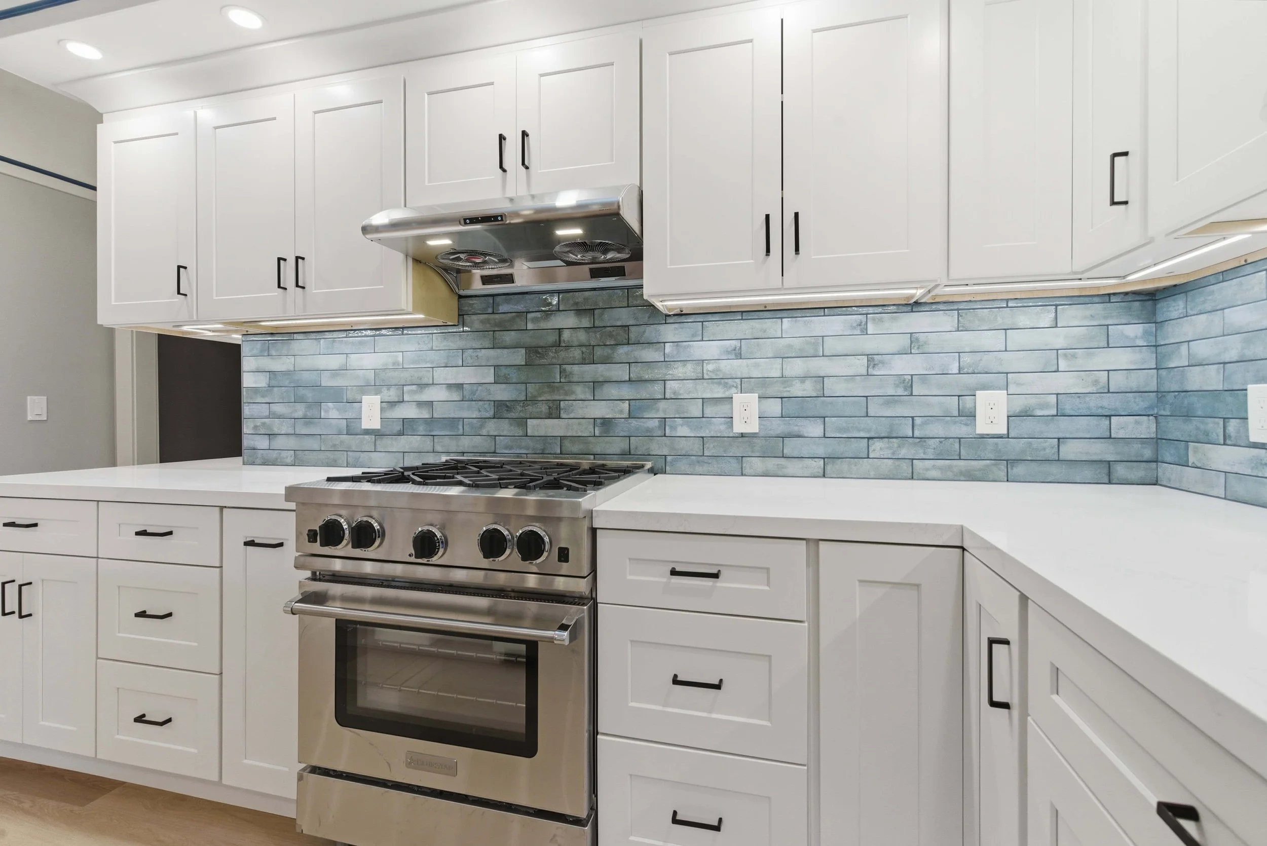 Naglee Park kitchen remodel with blue tiles, white cabinets, marble countertops, and stainless steel appliances.