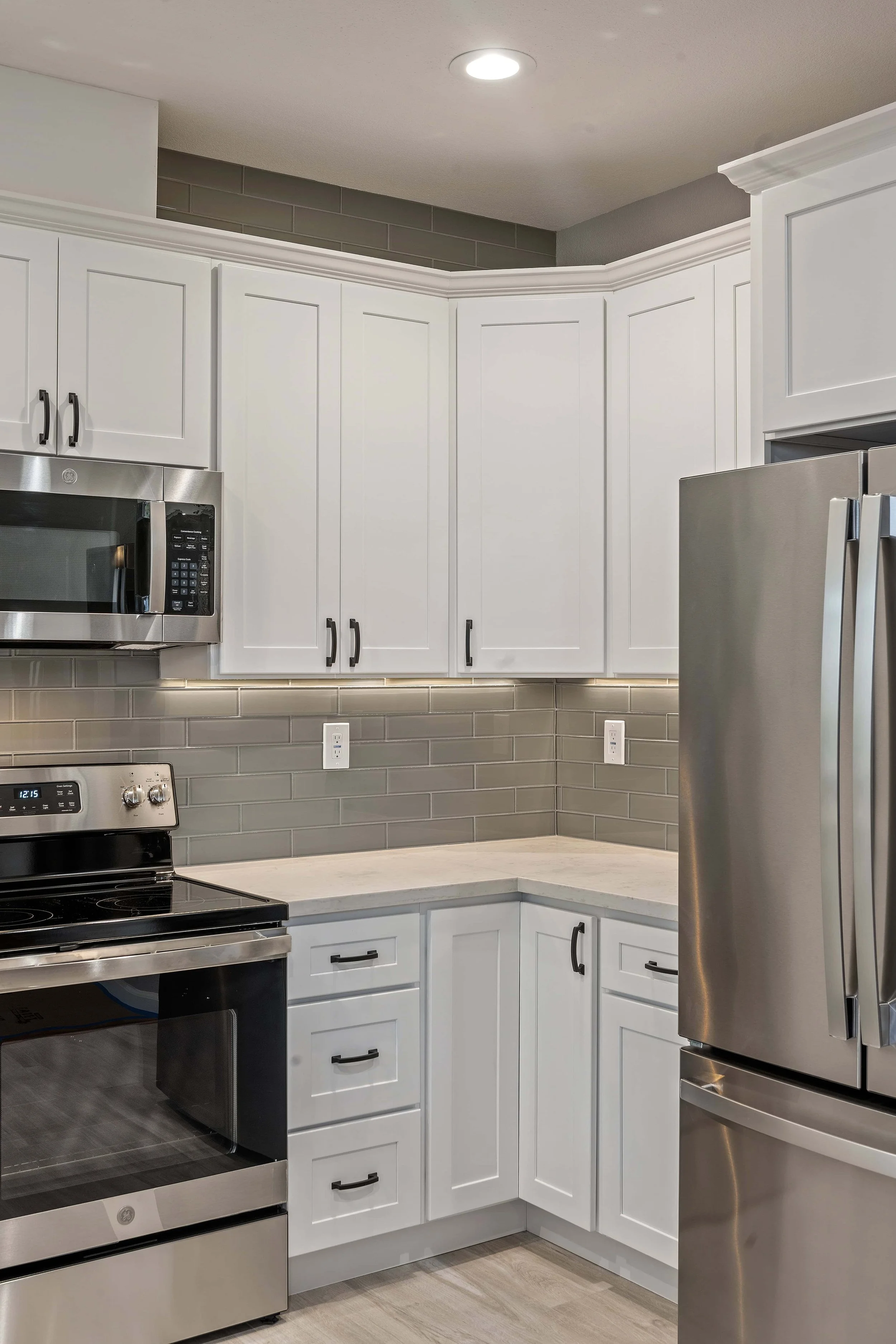 The corner of a remodeled kitchen in Cambrian Park, San Jose. A stainless steel stove and refrigerator is visible. 