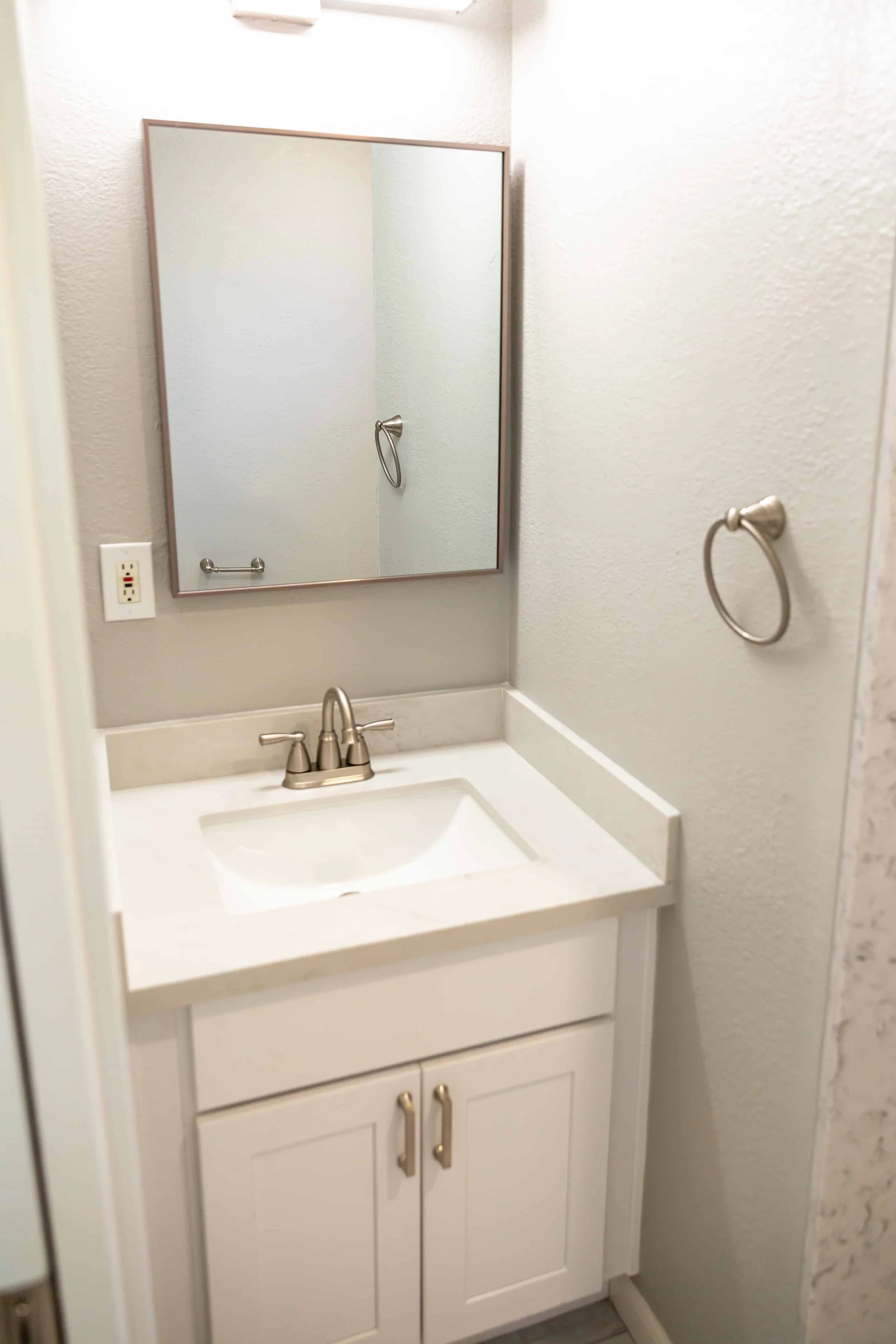A white sink in an ADU's renovated bathroom.