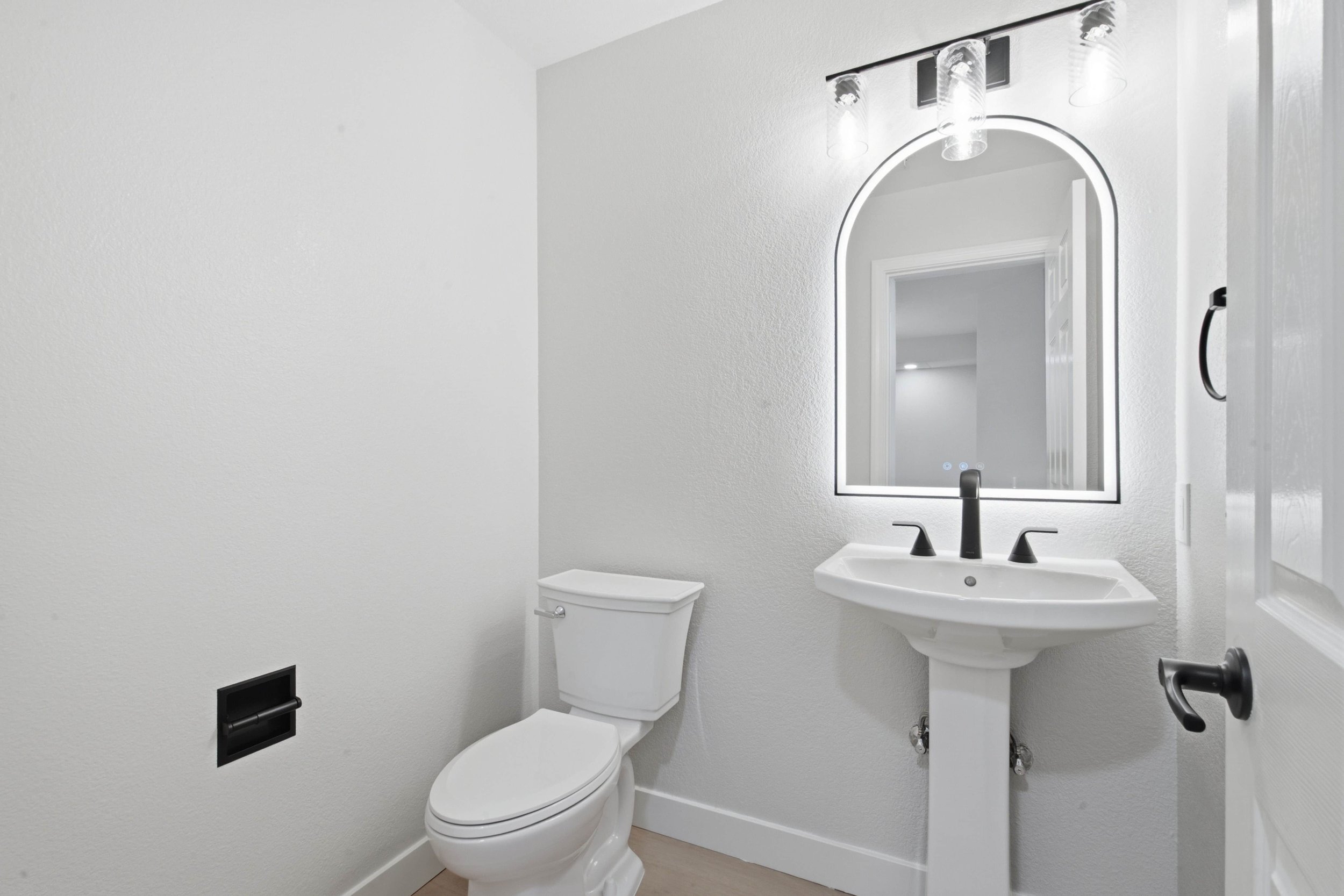 Remodeled bathroom in a Silicon Valley condominium. Gray walls with a new sink, toilet, vanity, lighting and faucet.