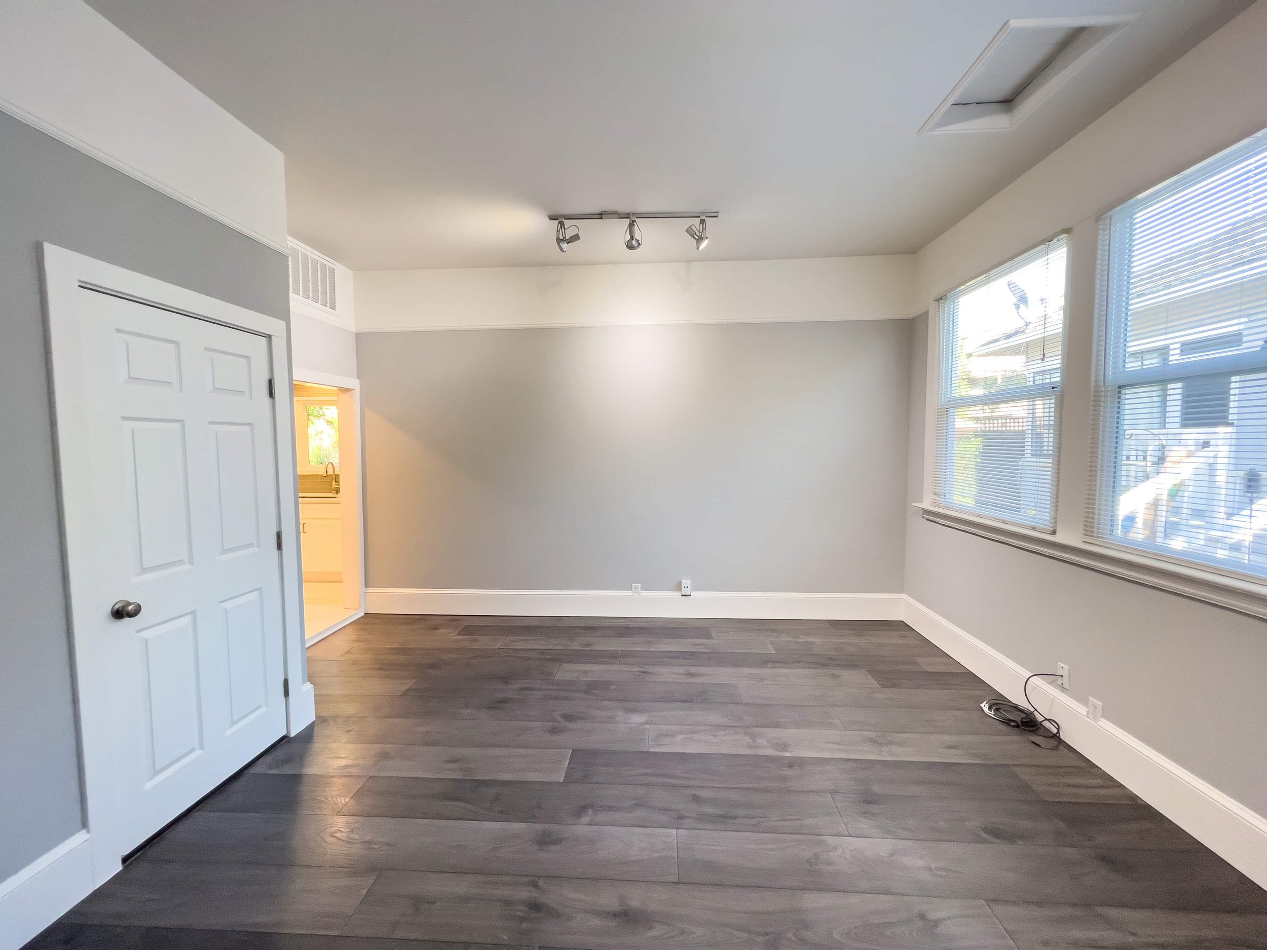Dark flooring in an ADU. The walls are warm grey with soft lighting.