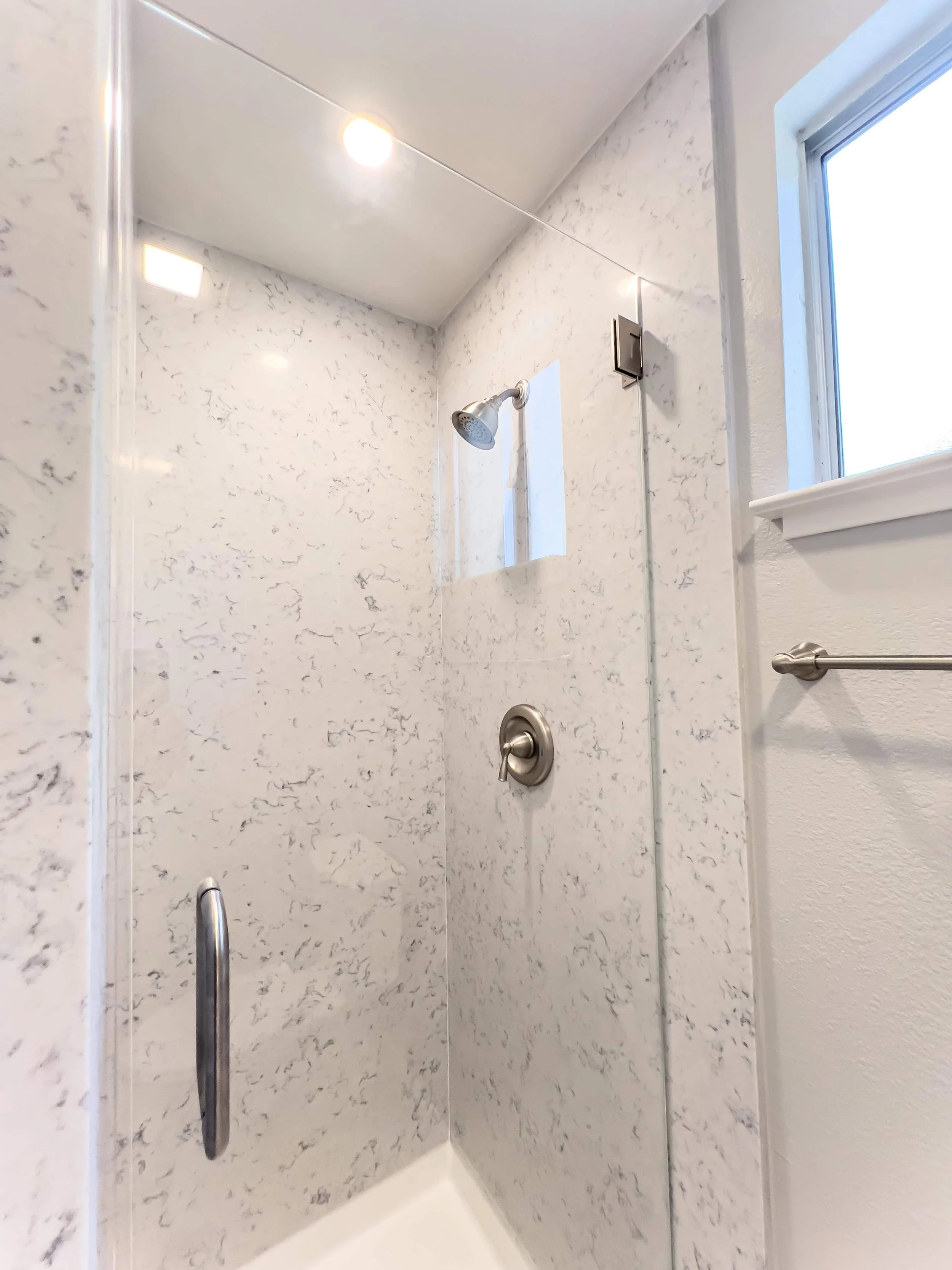 White marble shower surround in an ADU