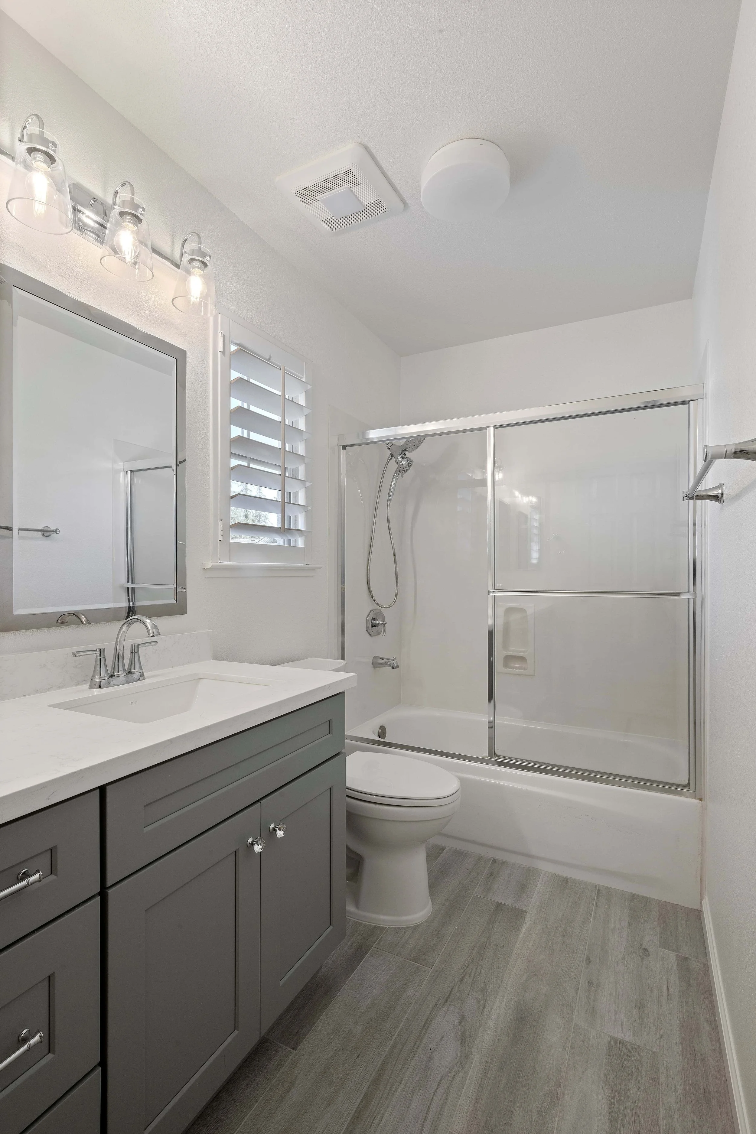 Gray vanity in a remodeled bathroom
