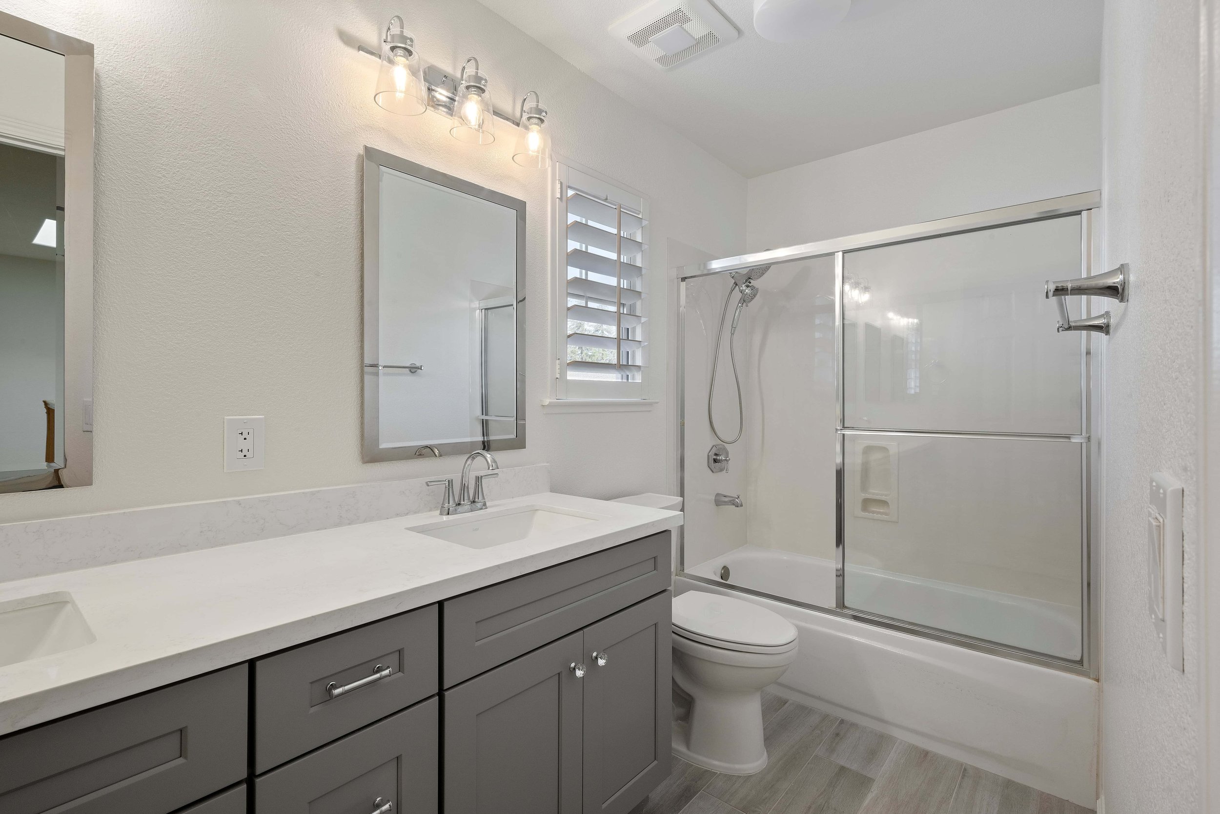 An angled shot of a grey vanity in a remodeled Cambrian Park bathroom. 