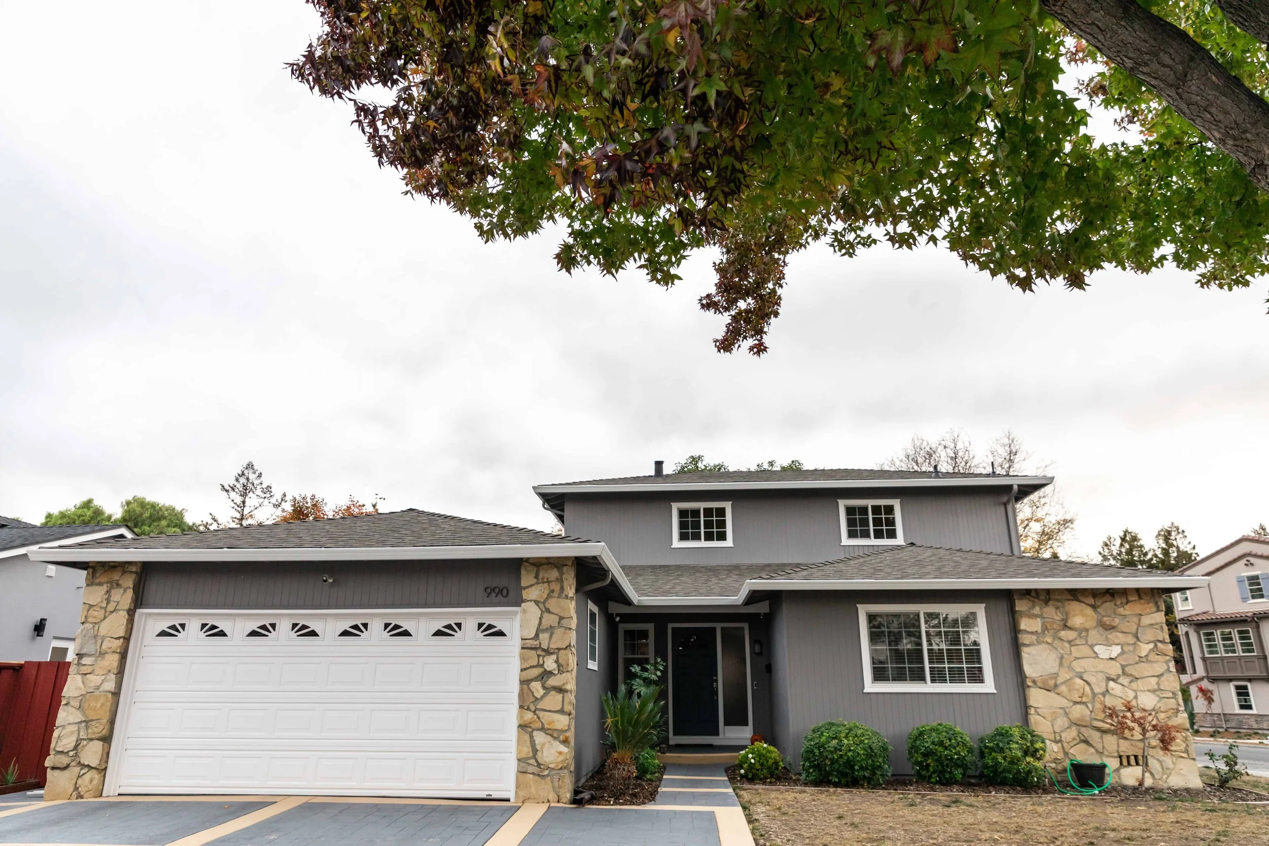  2 story house with stone and gray siding in San Jose.