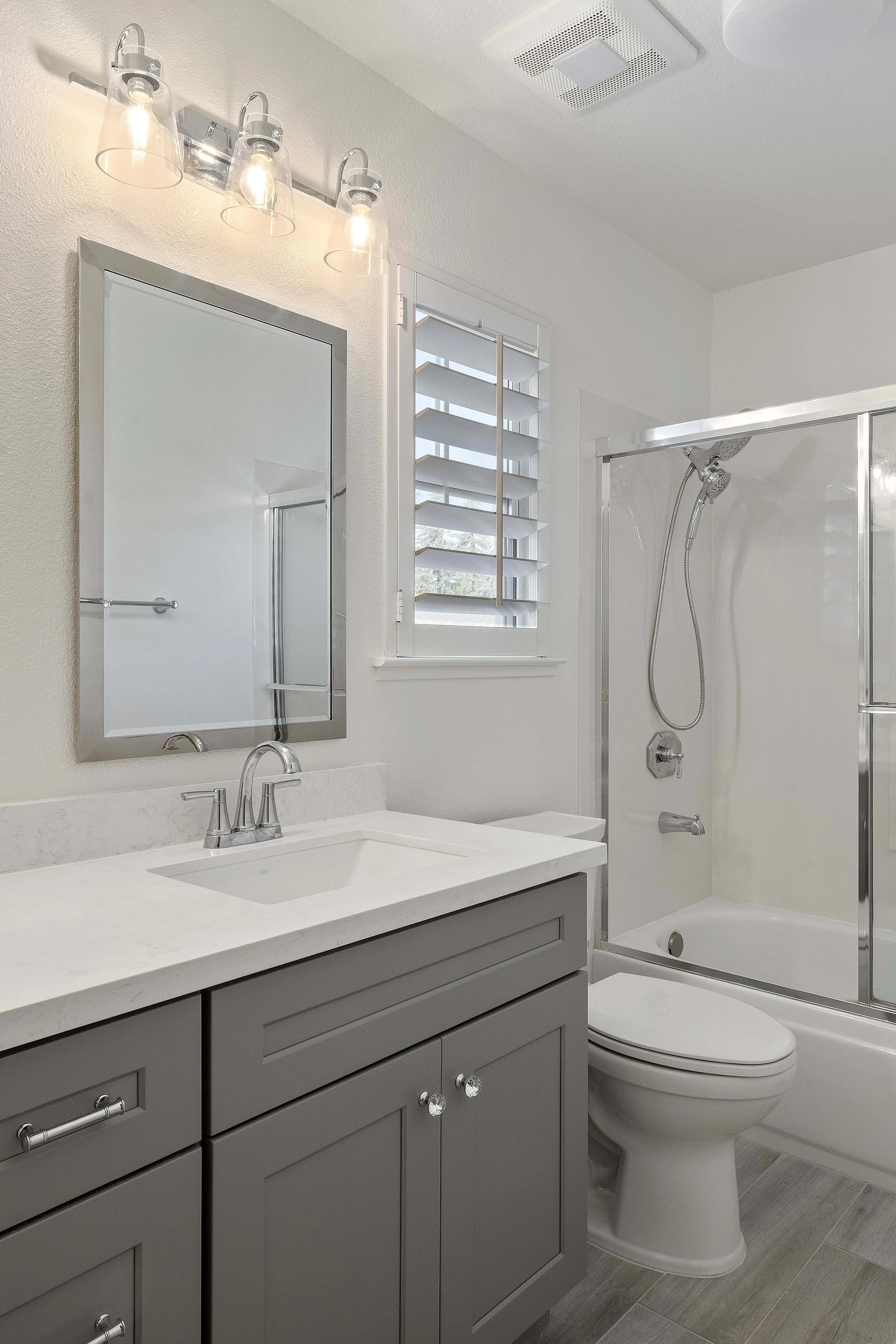 An angled shot of a grey vanity in a remodeled Cambrian Park bathroom. 