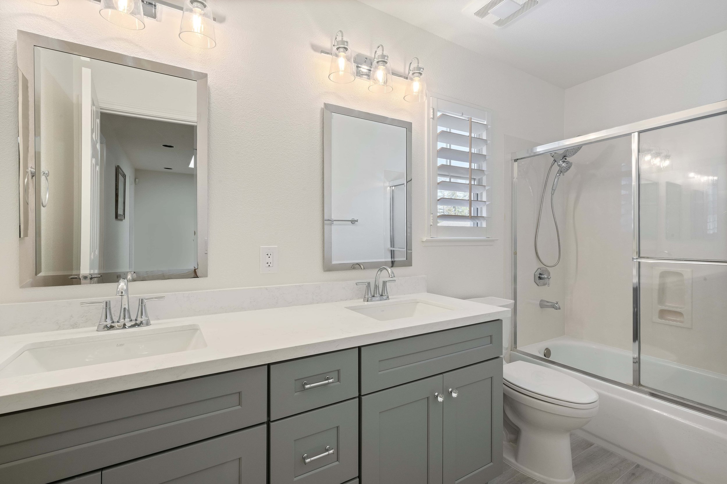 An angled shot of a grey vanity in a remodeled Cambrian Park bathroom. 