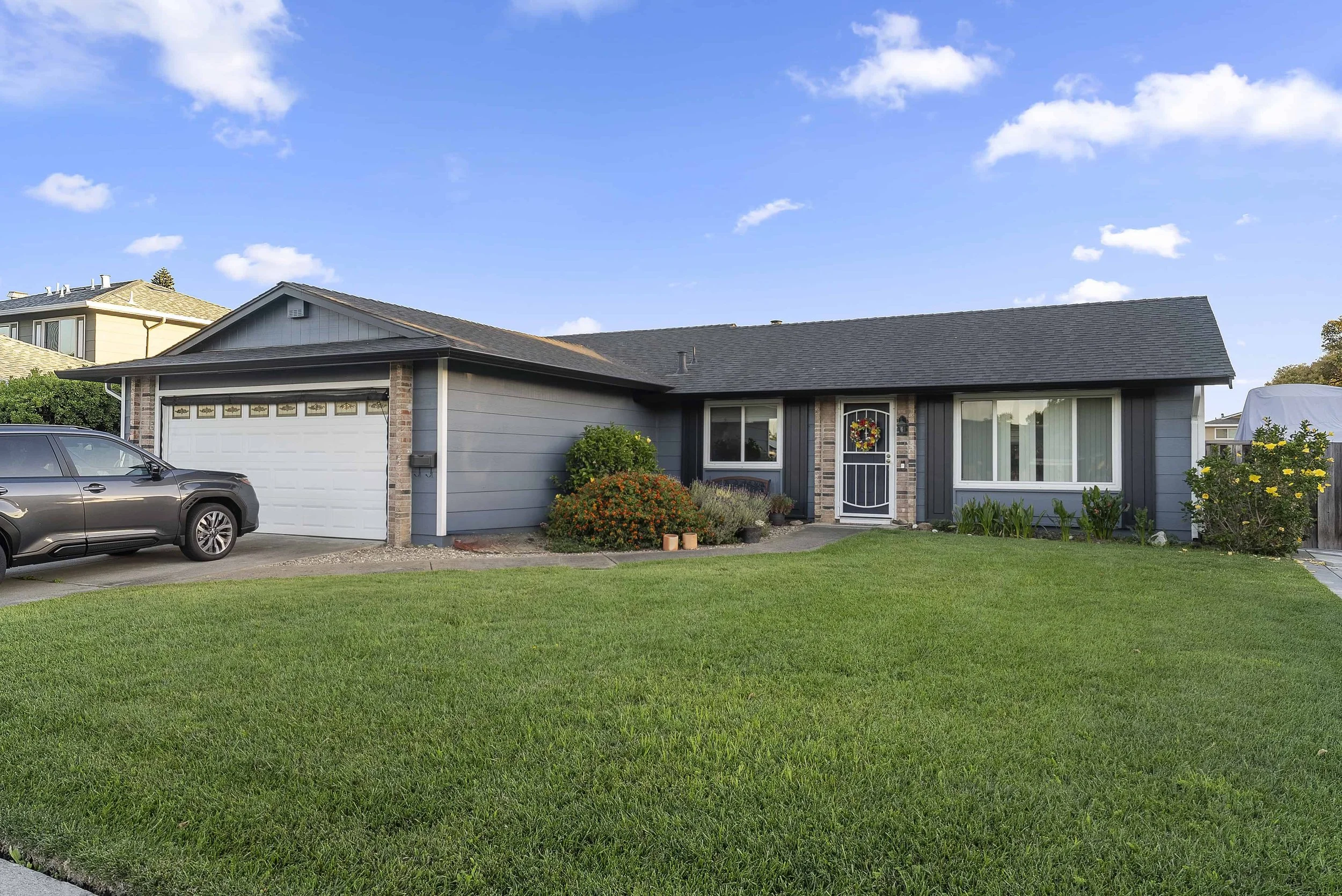 Single family one story home with gray siding.