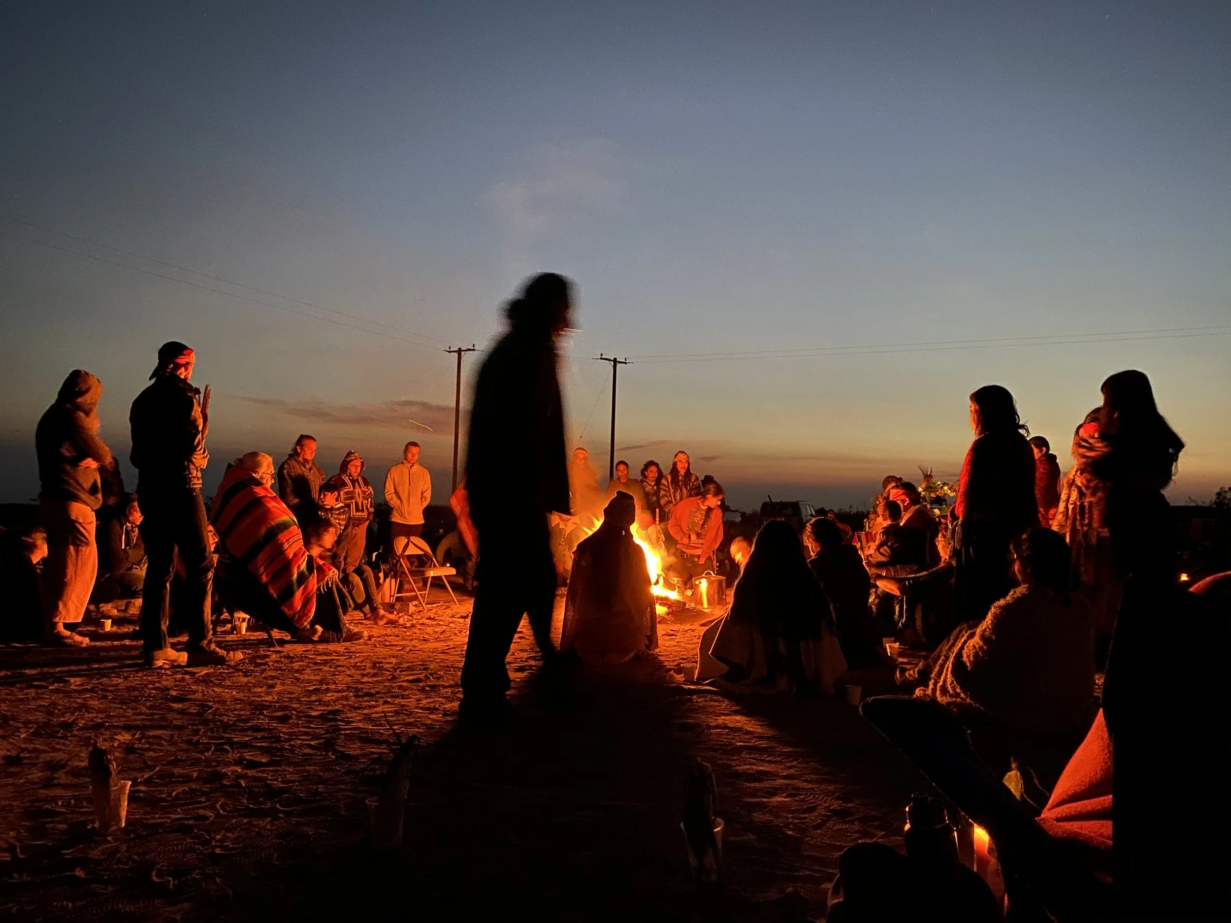 Samantha Juan gathered around a ceremonial fire during a healing ceremony in Dallas.