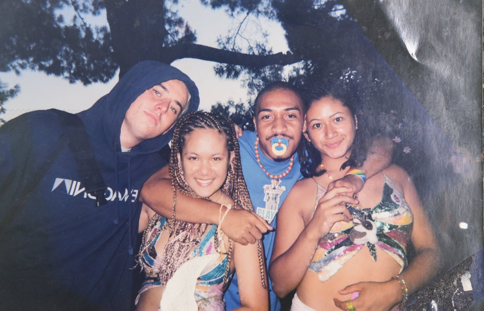 Samantha Juan smiling and embracing a group of friends during her time in Los Angeles.