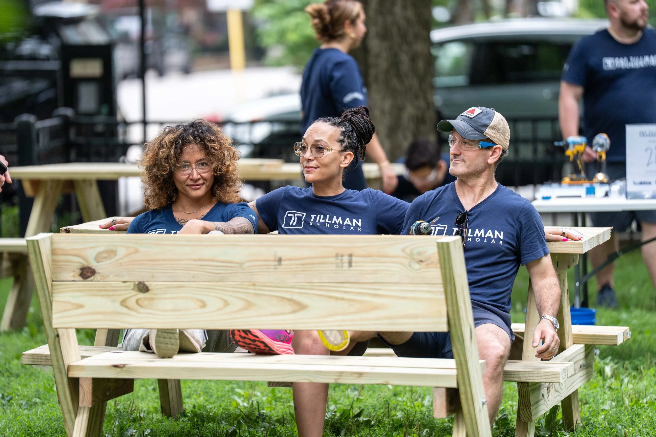 Samantha Juan and other participants building a wooden structure during an outdoor community event at Workhouse Arts Center.