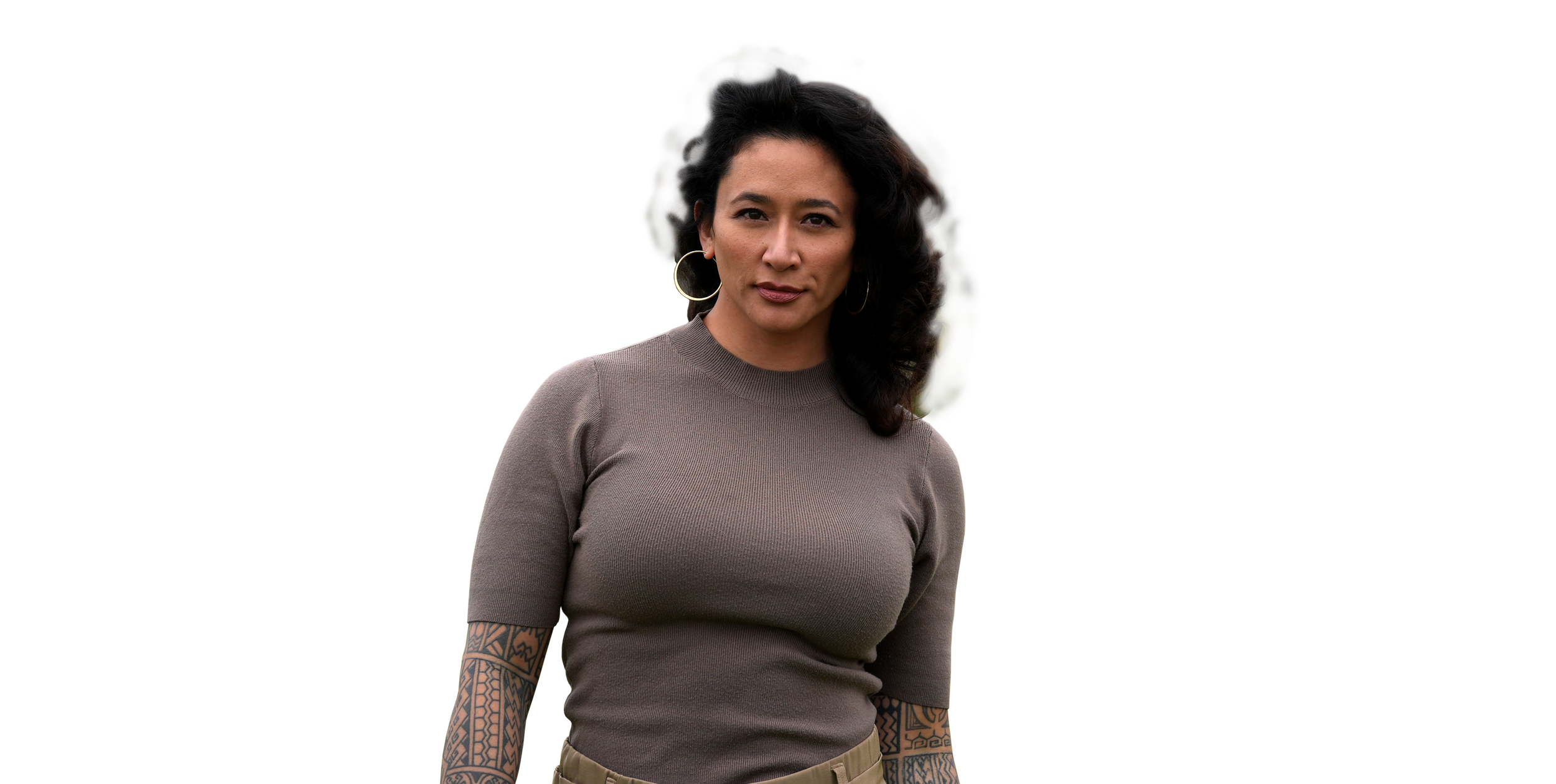 Samantha Juan smiling in a taupe top against a dark background.