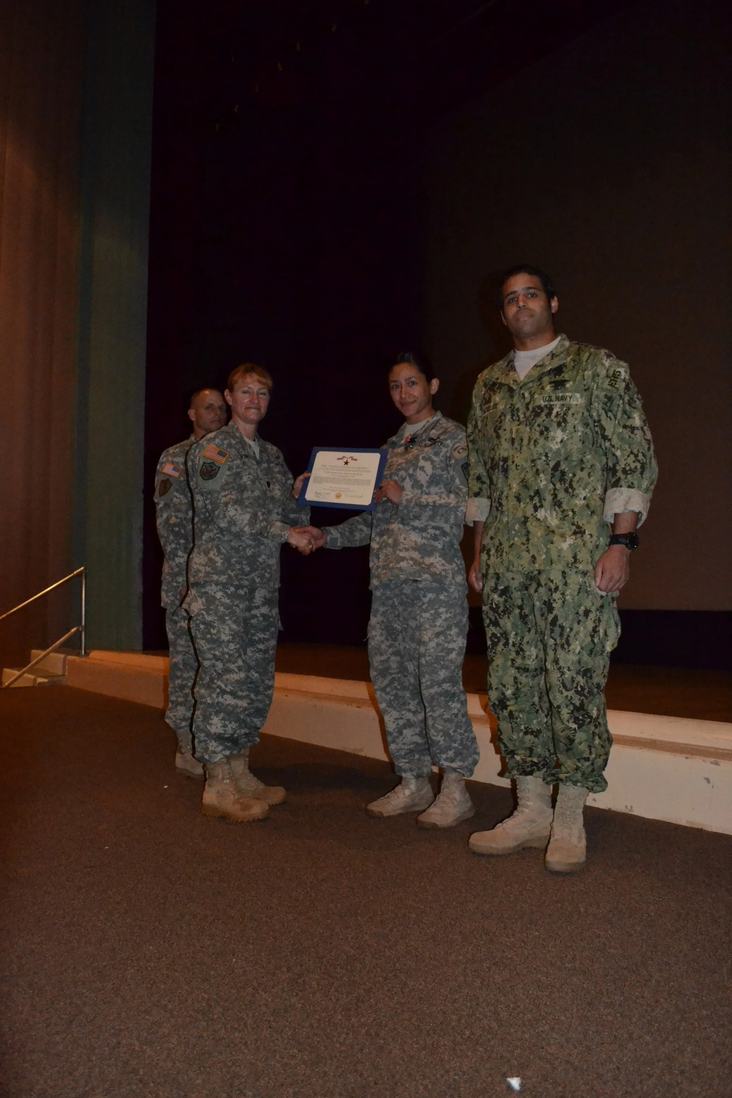 Samantha Juan receiving a certificate onstage while attending art school during her military service.