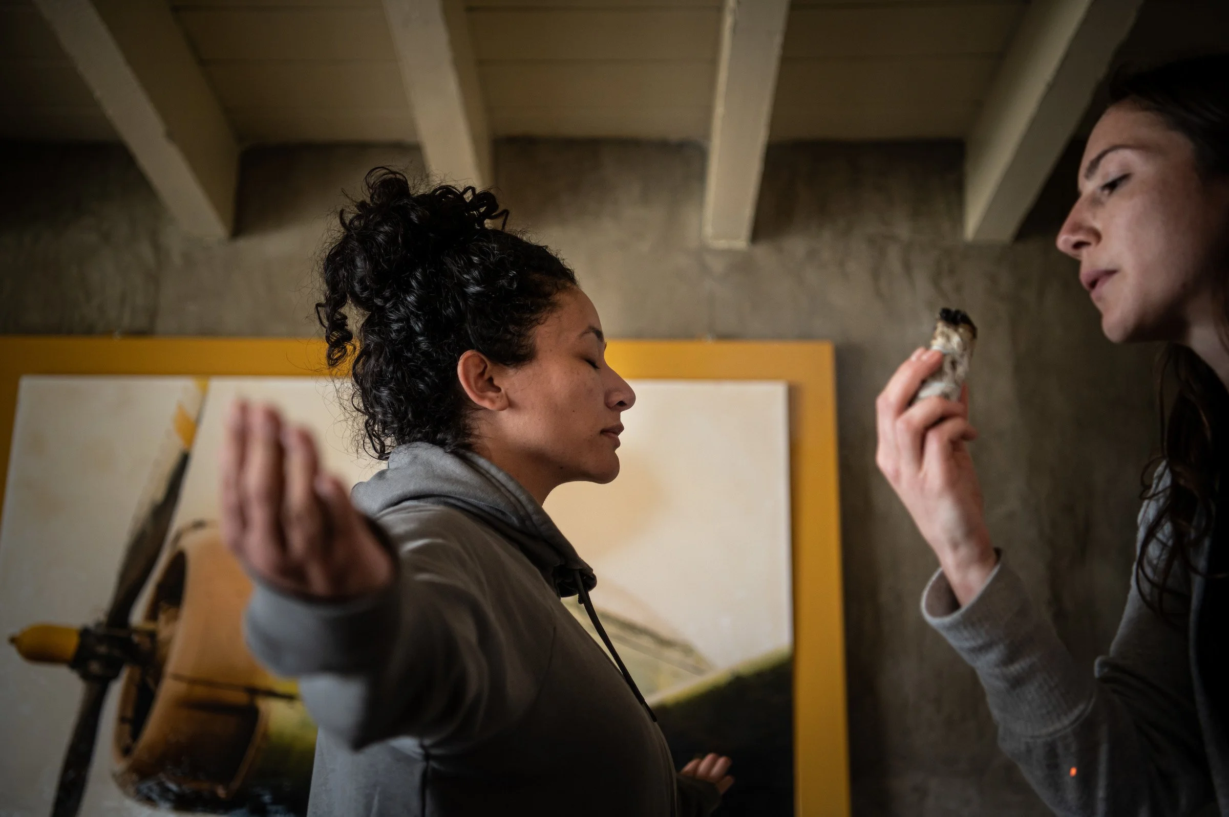Samantha Juan participating in a healing ceremony with another woman in Dallas.
