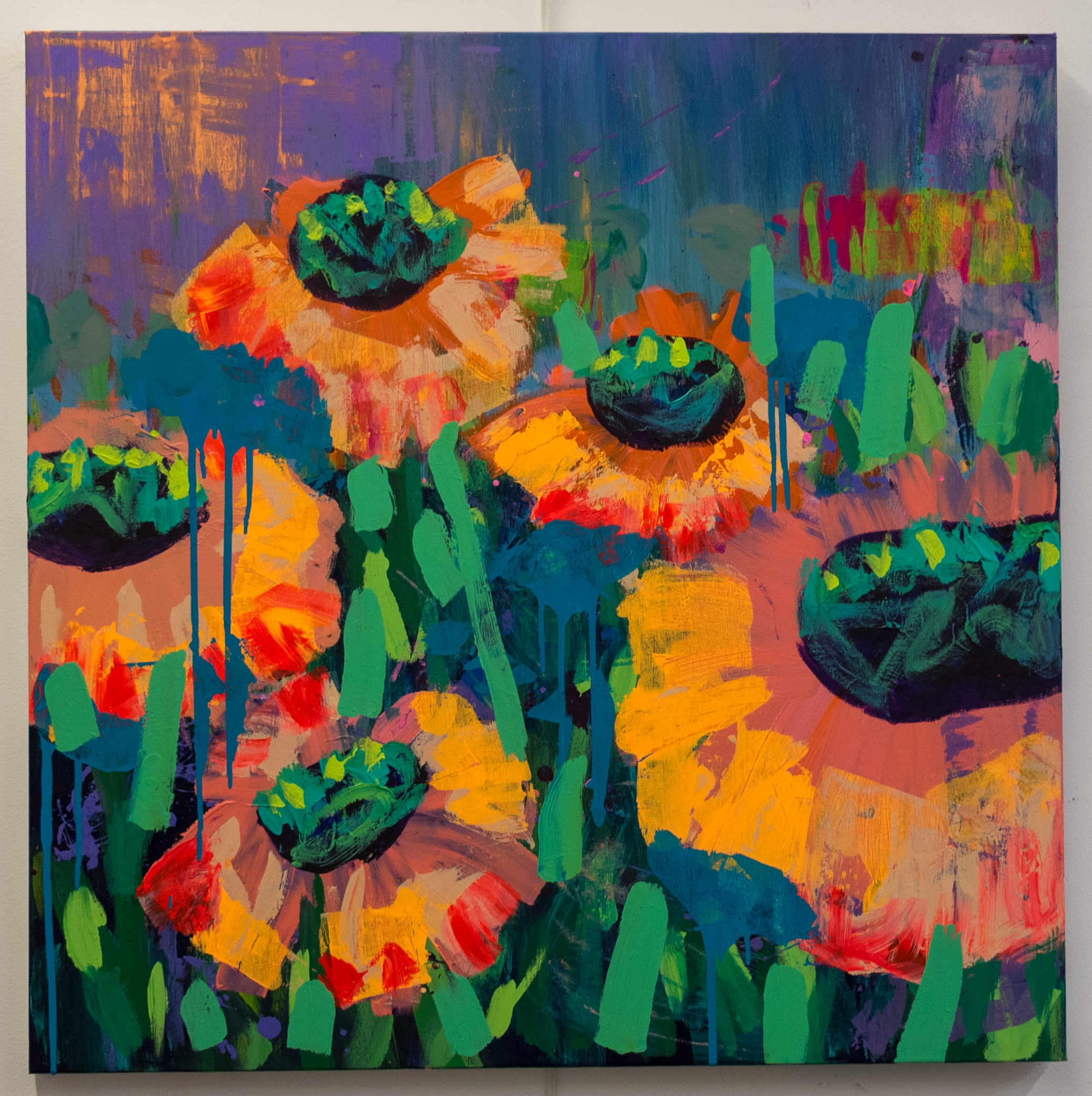 A colorful abstract painting with vibrant hues of purple, blue, orange, green, and red. It features bold, expressive brushstrokes and geometric shapes, including two prominent black circular elements. The background has textured layers, creating depth and movement.