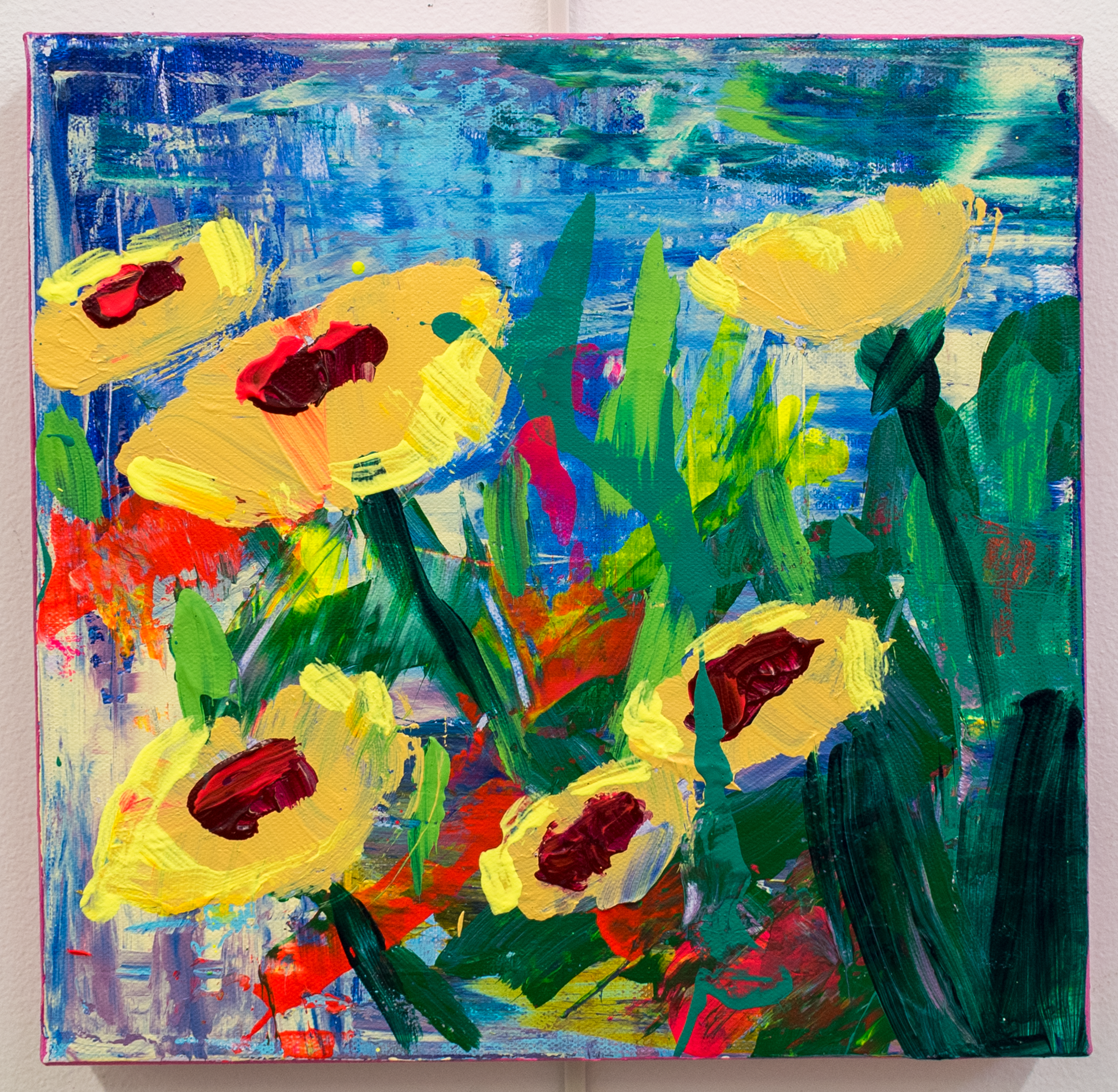Abstract colorful painting with yellow, red, green, blue, purple, and pink paint on canvas.