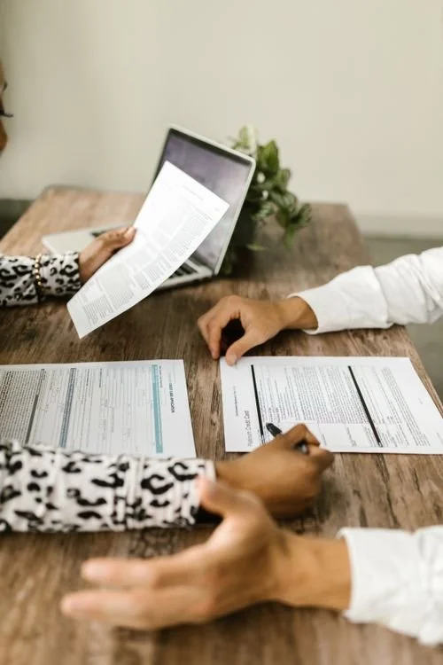 Two people discussing documents at a table