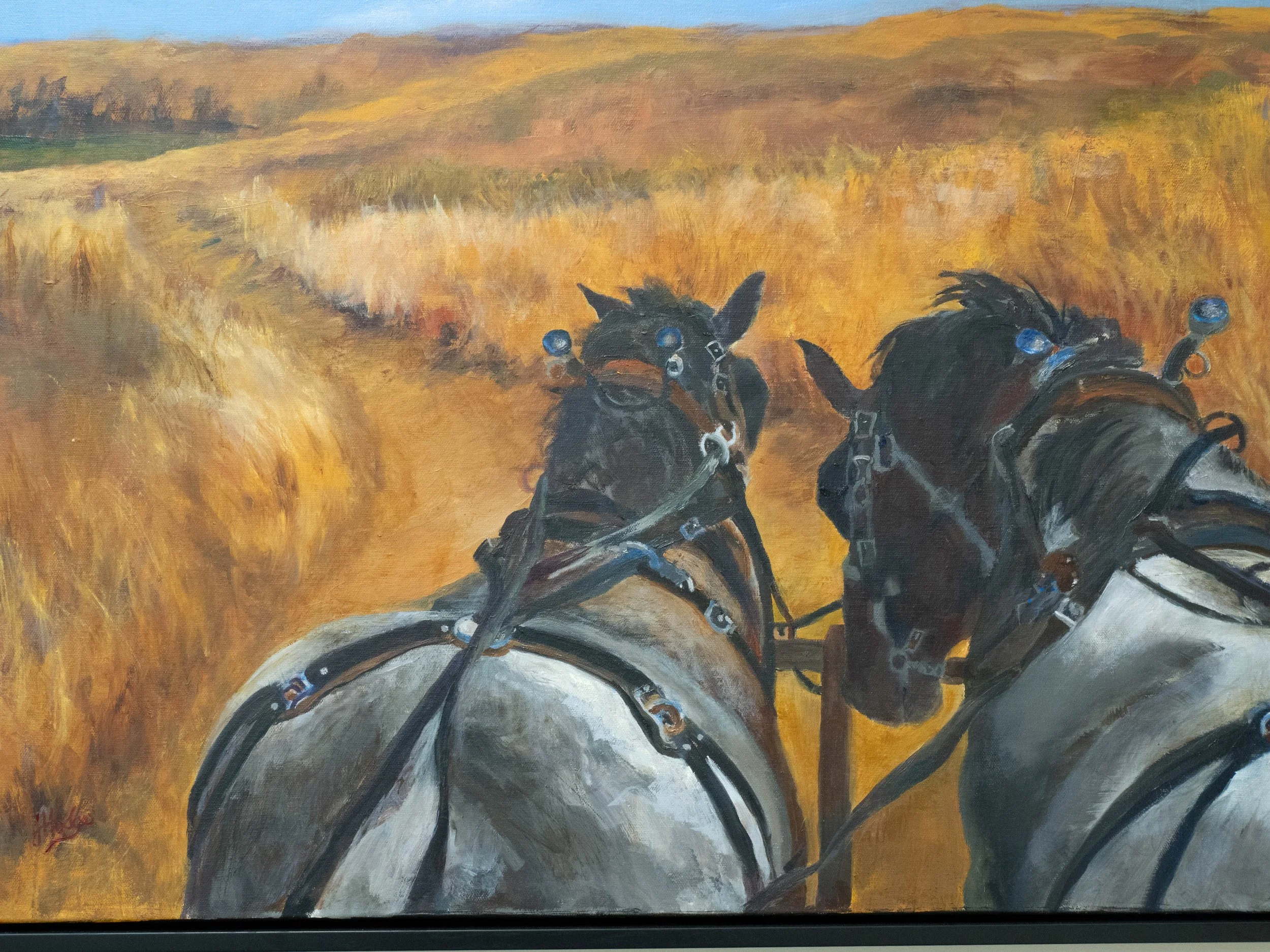 Painting of two black horses with bridles running through a landscape with yellow and brown fields and a blue sky.