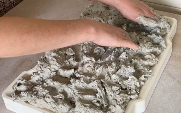 spreading-the-reclaimed-clay-on-the-plaster-slab.jpg