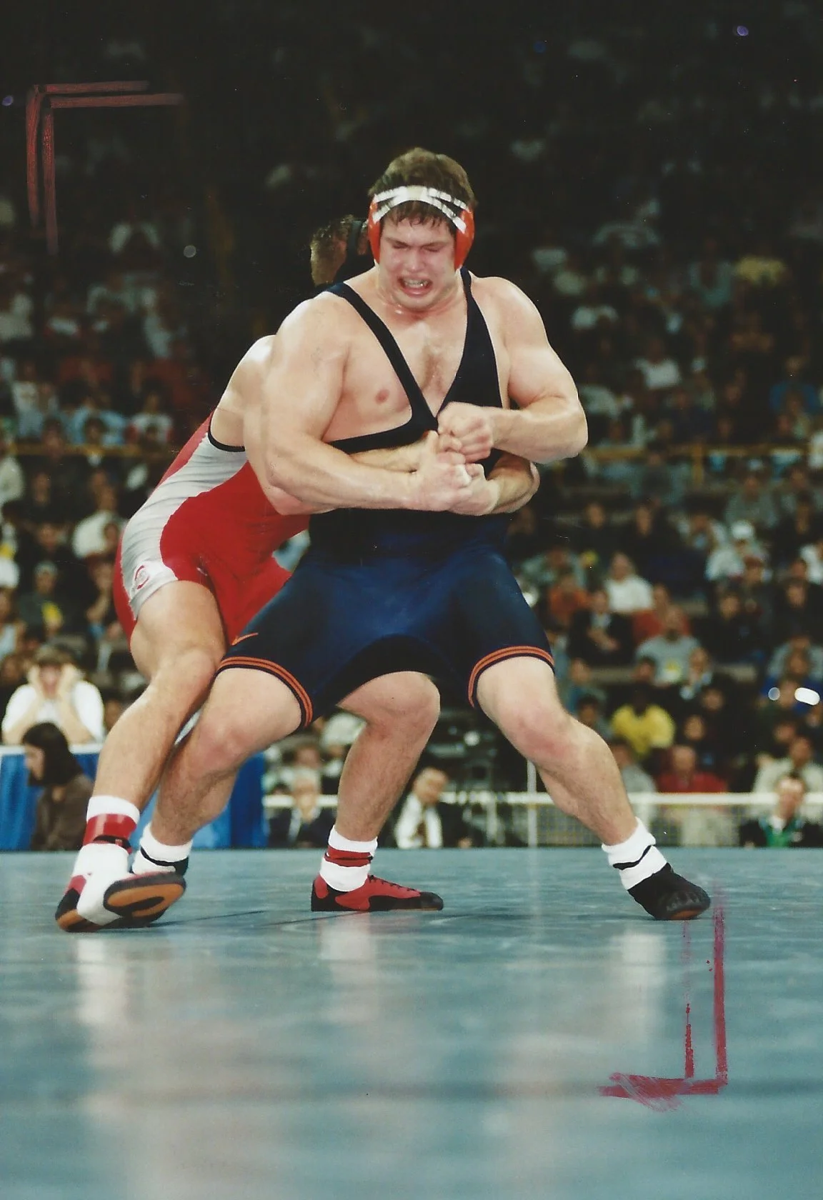 John Lockhart fighting hard to break the locked hands of his opponent in the NCAA national finals where he ultimately won the match by escape from the bottom position in overtime.