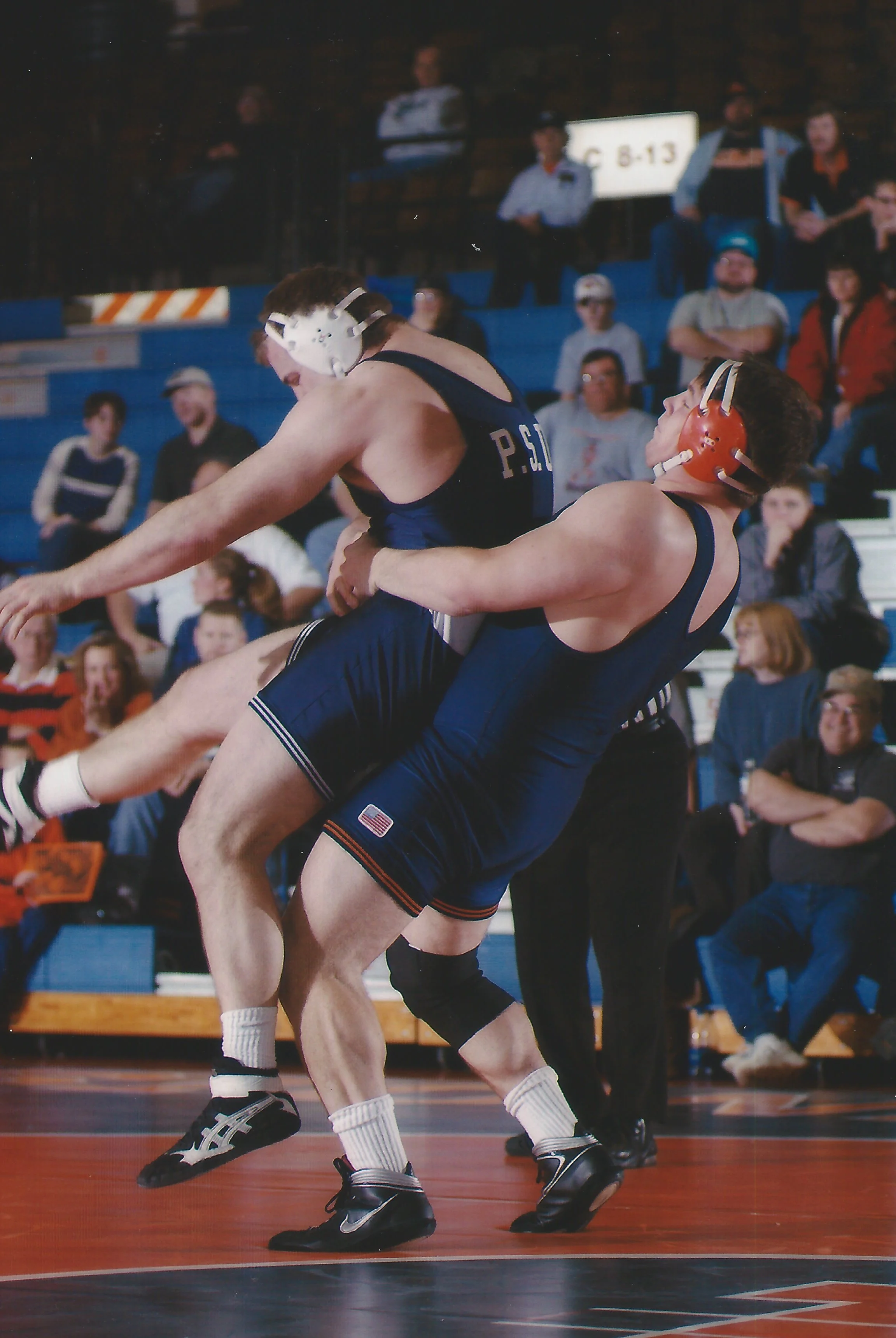John Lockhart lifting his Penn State opponent to return him to the mat during a Home match at Huff Hall for university of Illinois.  Lockhart was a three-time all American and NCAA national champion for the Illini during his career. 