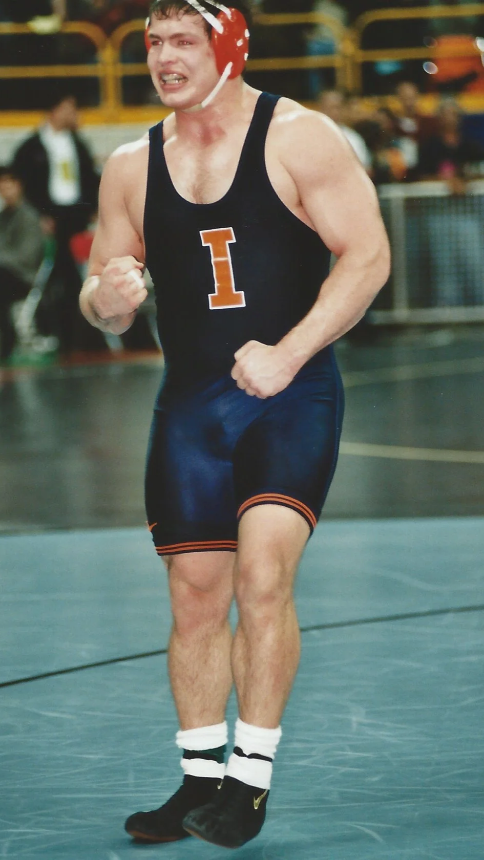 Dr. John Lockhart wrestling for University of Illinois at the NCAA tournament reacts to taking the lead in a close match