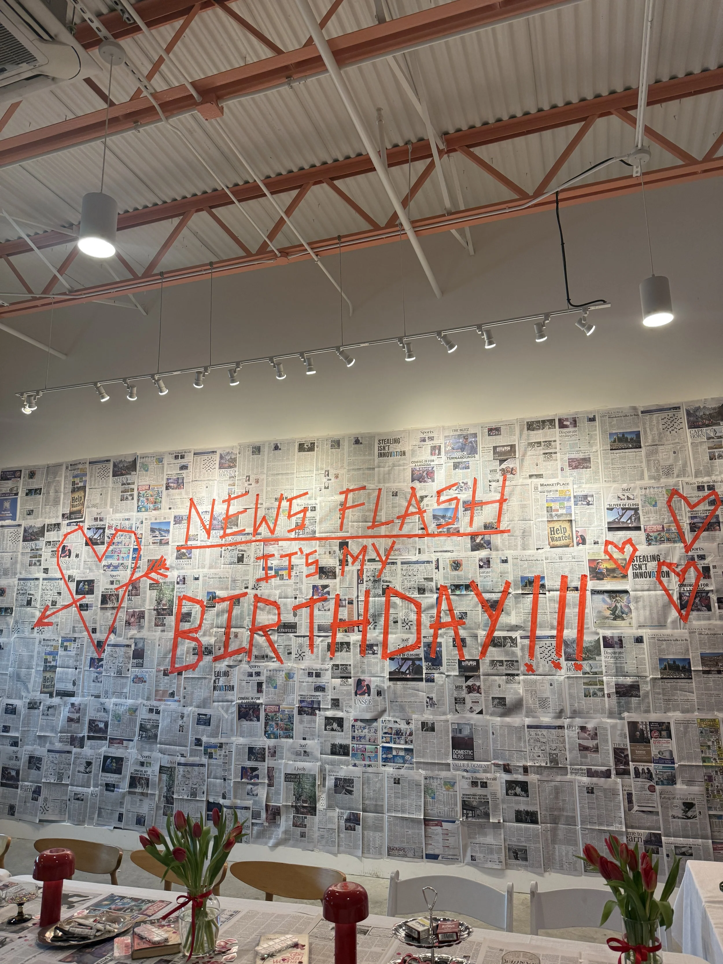 Newspaper wall install with tape text graphic | designer, installer | Client project
