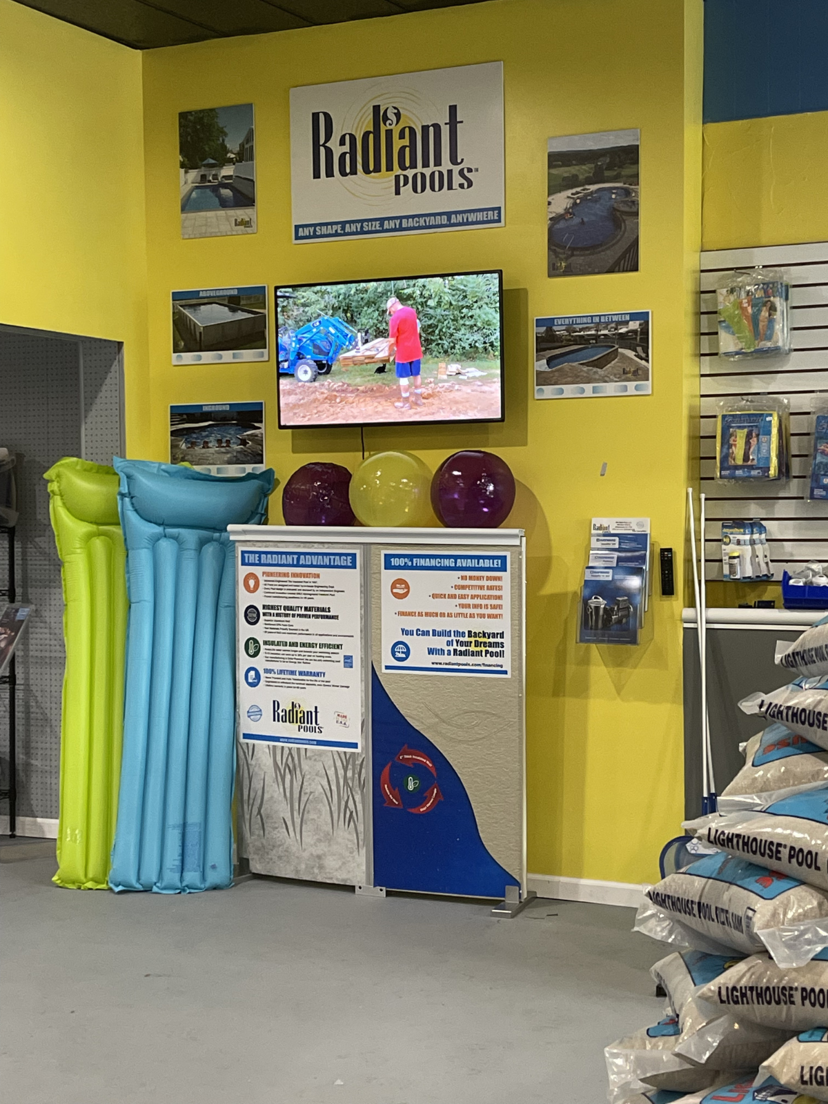 Interior of the Man Made Pools storefront featuring pool supplies, accessories, and Radiant Pools displays.